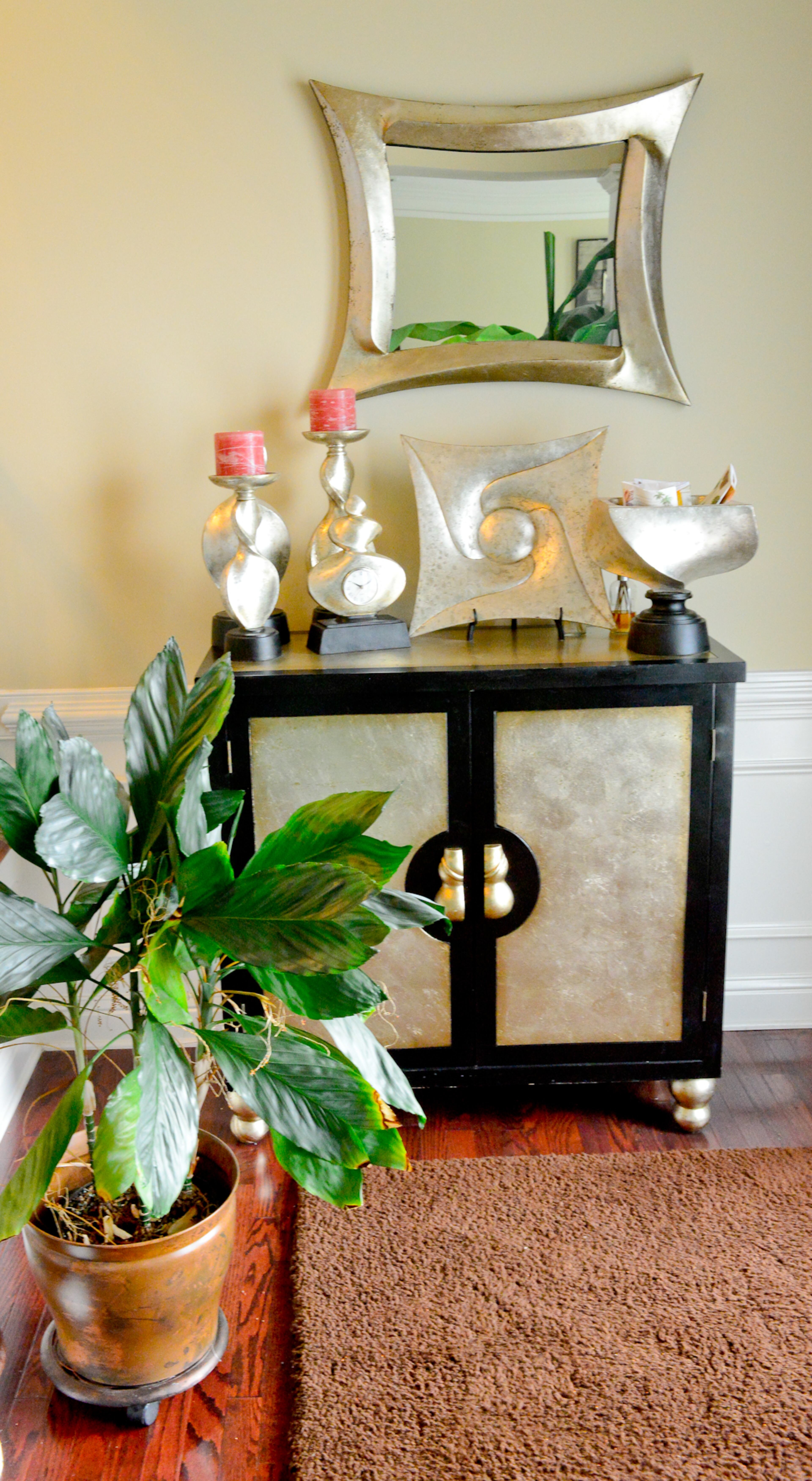 For the foyer, Frances Pace bought the mirror, the chest and the candleholders all from Rooms To Go.