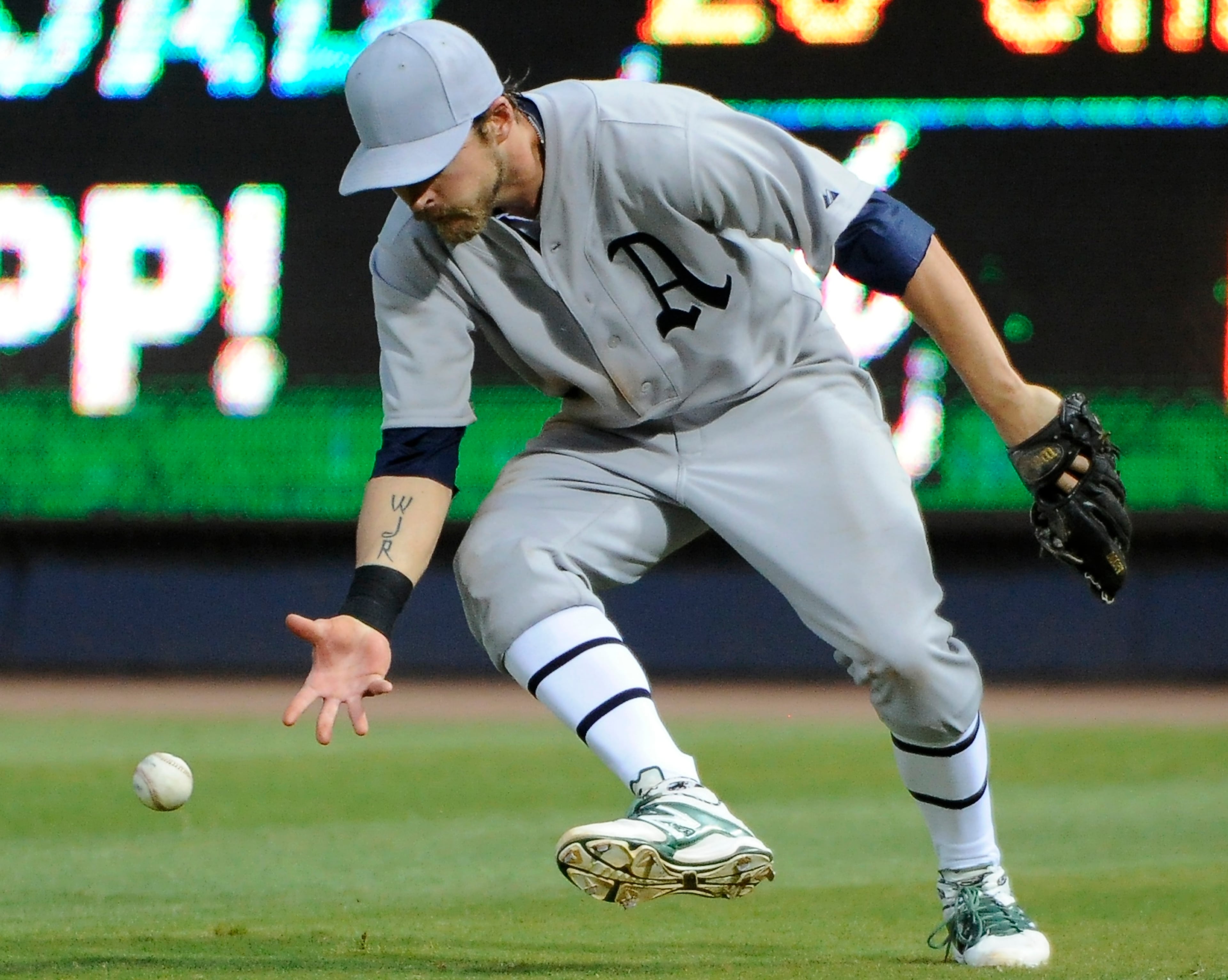 Oakland Athletics right fielder Josh Reddick misplays the blooper by Atlanta Braves' Chris Johnson for a single during the fourth inning of a baseball game Saturday, Aug. 16, 2014, in Atlanta. (AP Photo/David Tulis)