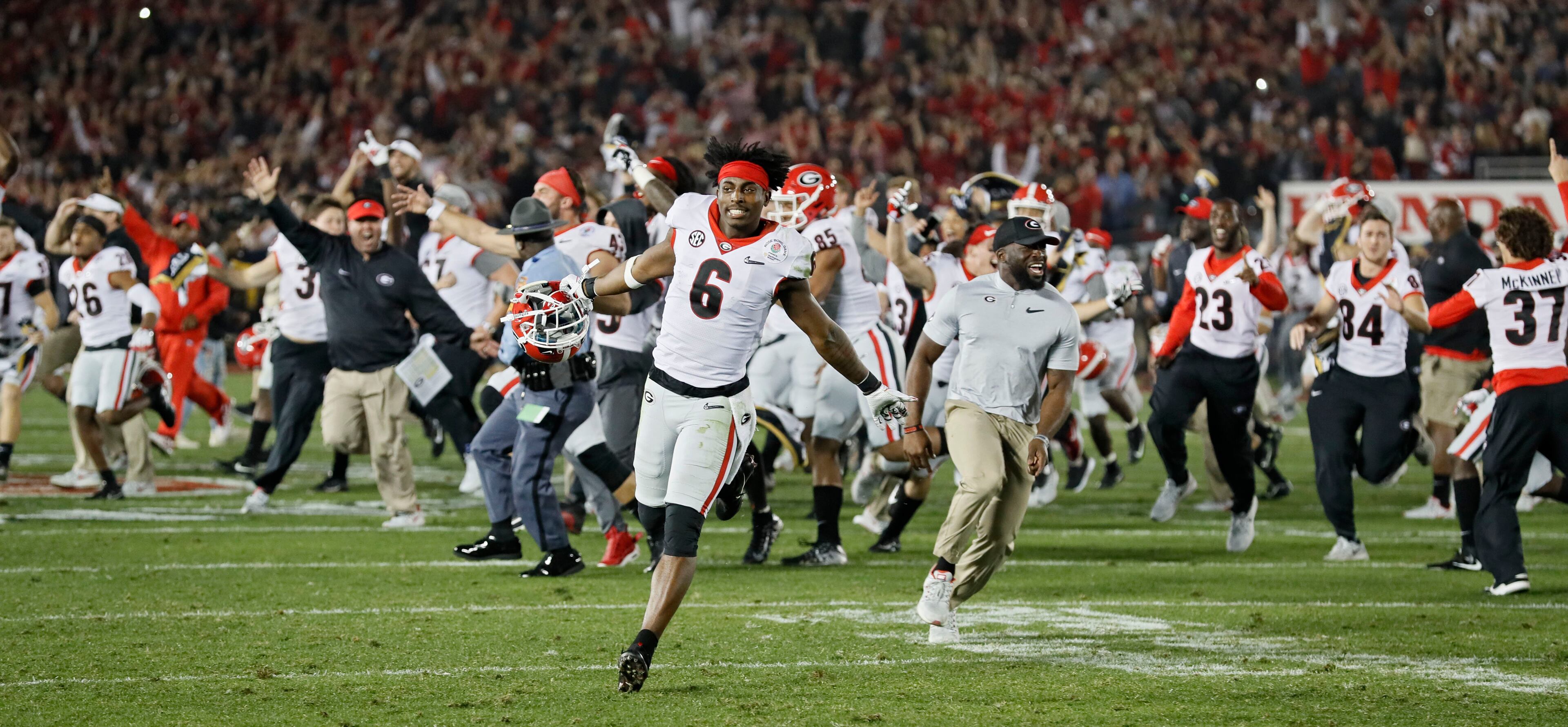 1/1/18 - Pasadena - Georgia players celebrate after scoring a touchdown during the second overtime period of the College Football Playoff Semifinal at the Rose Bowl Game on Monday, January 1, 2018, in Pasadena. Georgia won 54-48. BOB ANDRES /BANDRES@AJC.COM