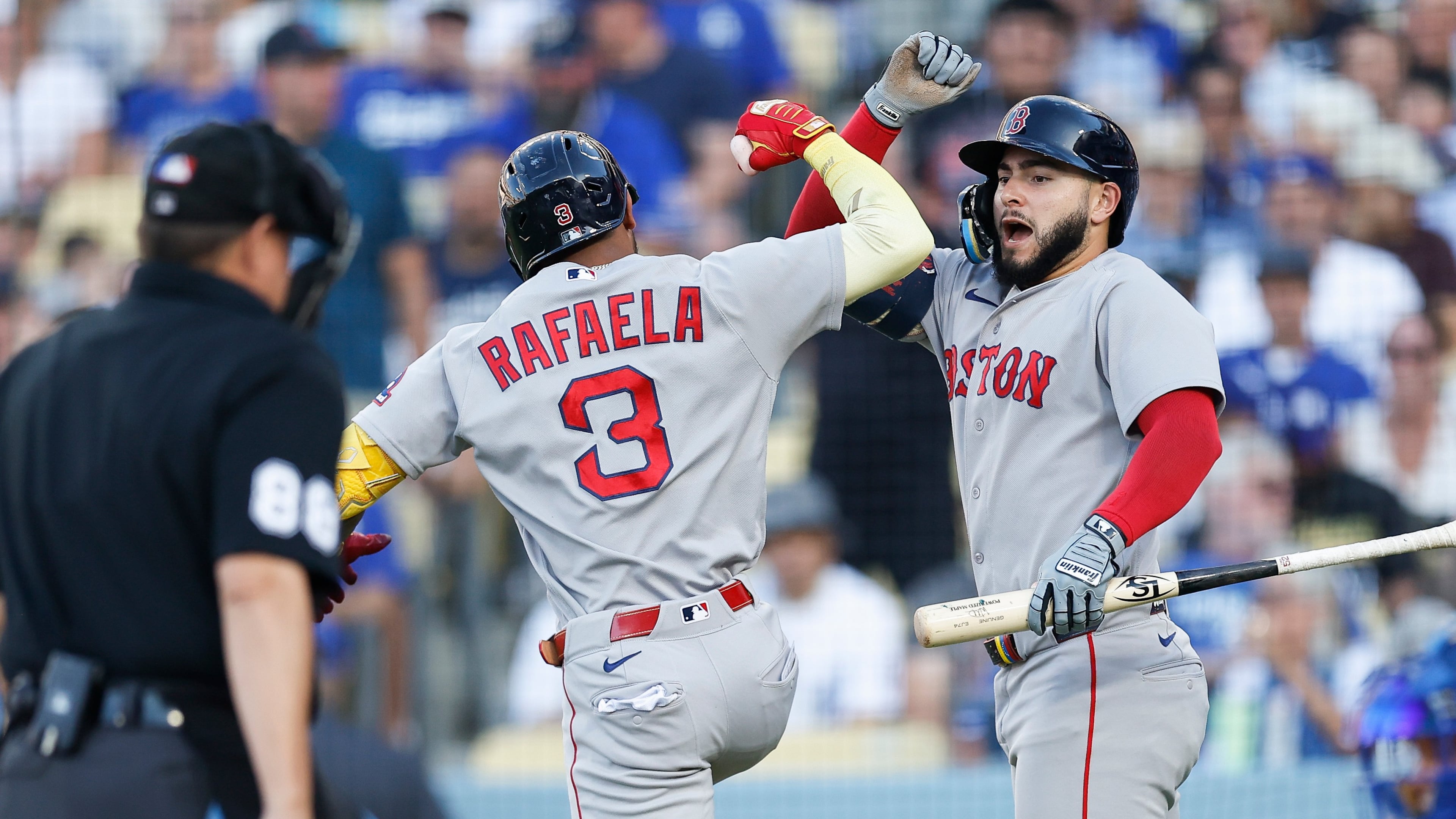 Boston Red Sox's Ceddanne Rafaela (3), left, is greeted by Boston Red Sox's Wilyer Abreu (52) after hitting a solo home run during the first inning of a baseball game against the Los Angeles Dodgers, Saturday, Aug. 1, 2026, in Los Angeles. (AP Photo/Caroline Brehman)