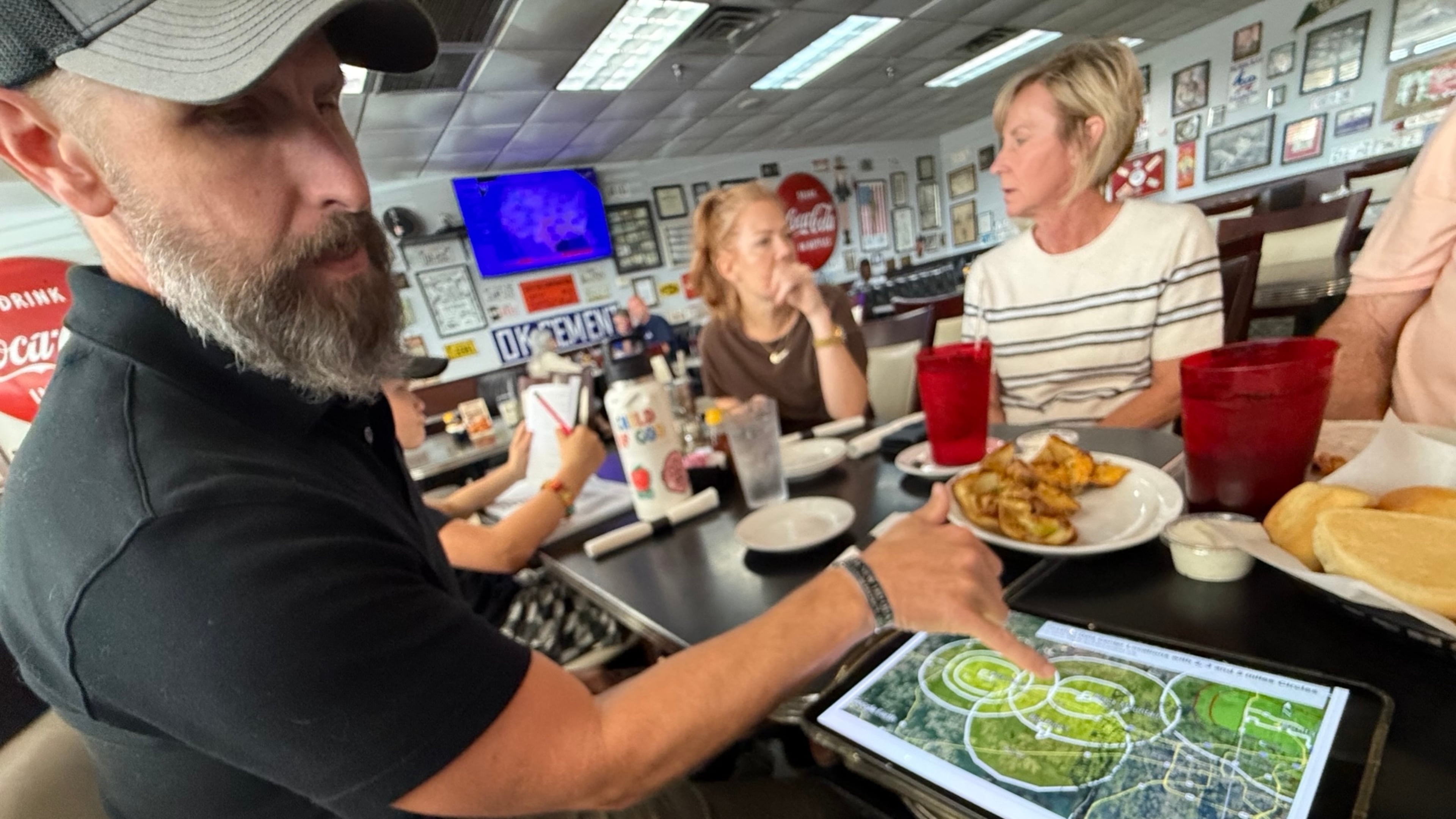 Justin Koch shows a map of proposed data center projects in Bowie County, Texas. Since retiring from the U.S. Army, he's dedicated his time and resources to fighting the developments, including one project proposed by a firm linked to Republican Rick Jackson. (Greg Bluestein/AJC)