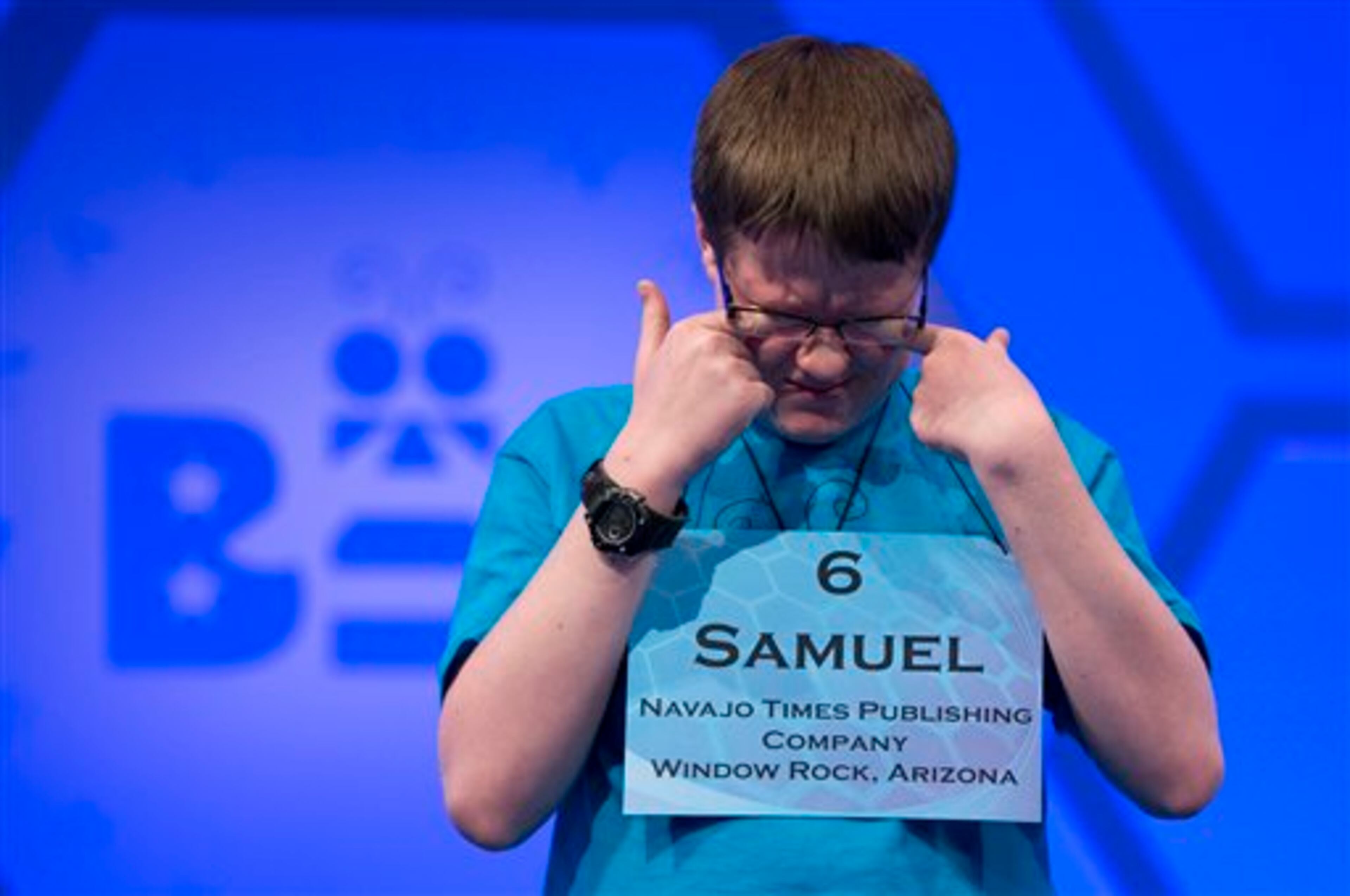 Samuel Yeager, of Chinle, Ariz., wipes his eyes while waiting for his turn during the third round of the National Spelling Bee, Wednesday, May 29, 2013, in Oxon Hill, Md. Yeager spelled the word "yannigan" incorrectly. (AP Photo/Evan Vucci)