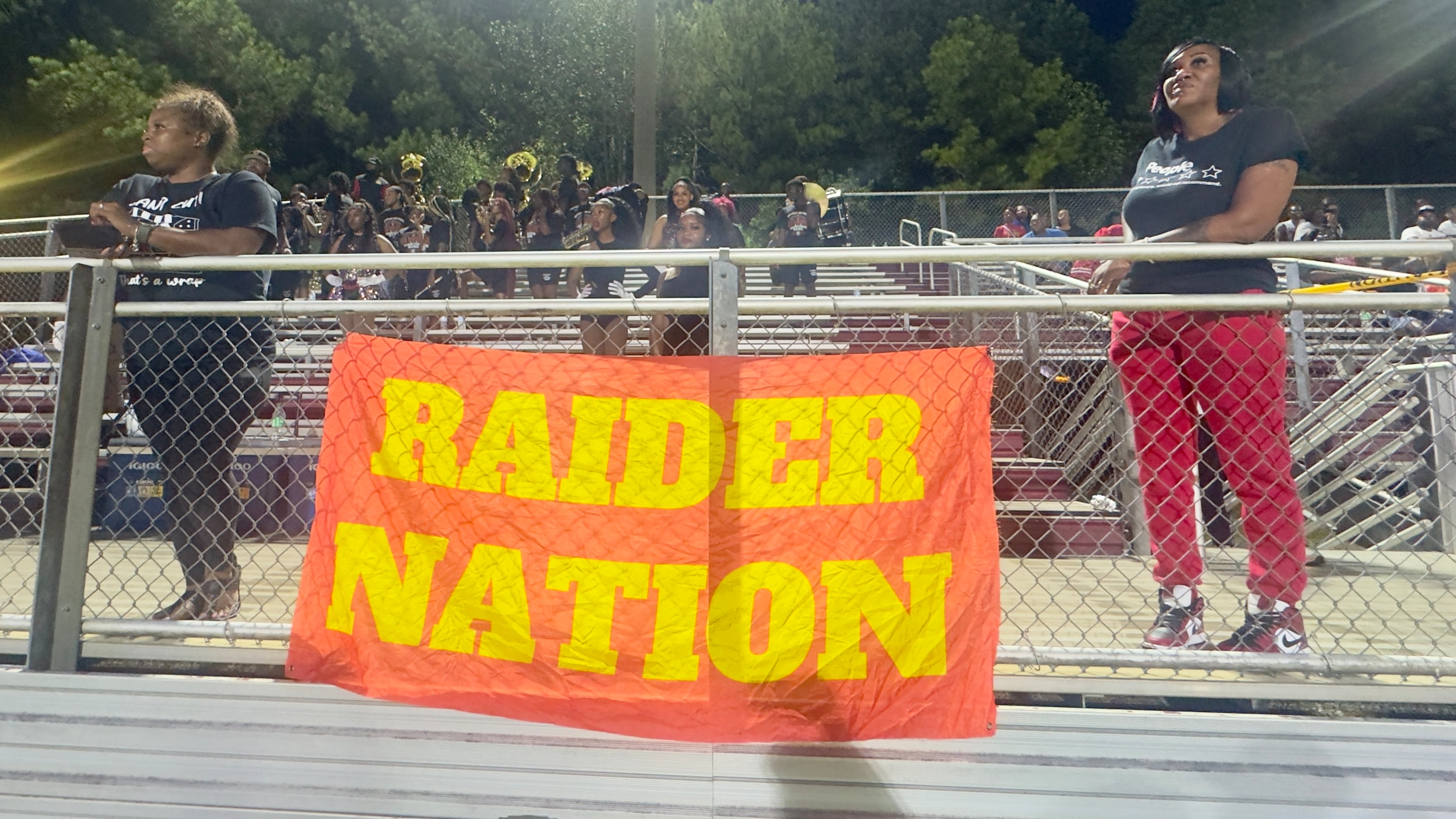 Northeast High School supporters watch Thursday's game in Macon, the Raiders' first since a shooting left 12 teens, five of them Northeast football players, wounded at an impromptu birthday gathering Sunday, Sept. 27, 2026. (Joe Kovac Jr./AJC)