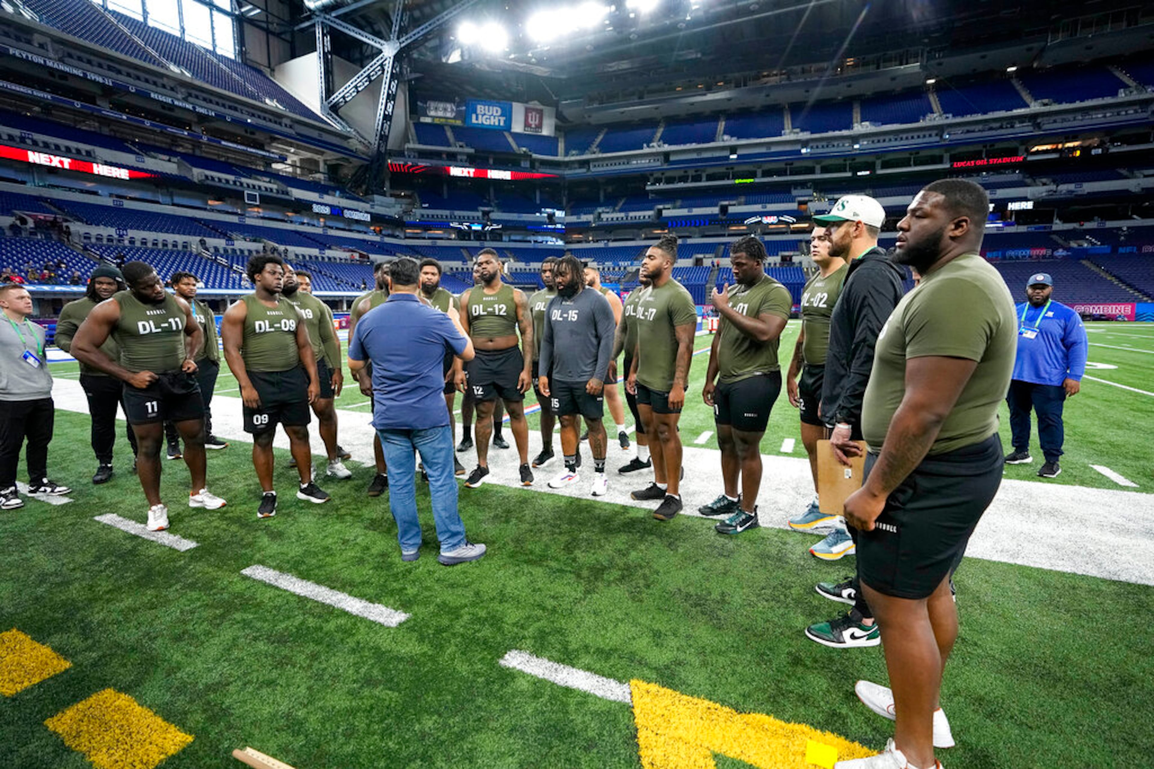 Defensive linemen gather before the 40-yard dash at the NFL football scouting combine in Indianapolis, Thursday, March 2, 2023. (AP Photo/Darron Cummings)