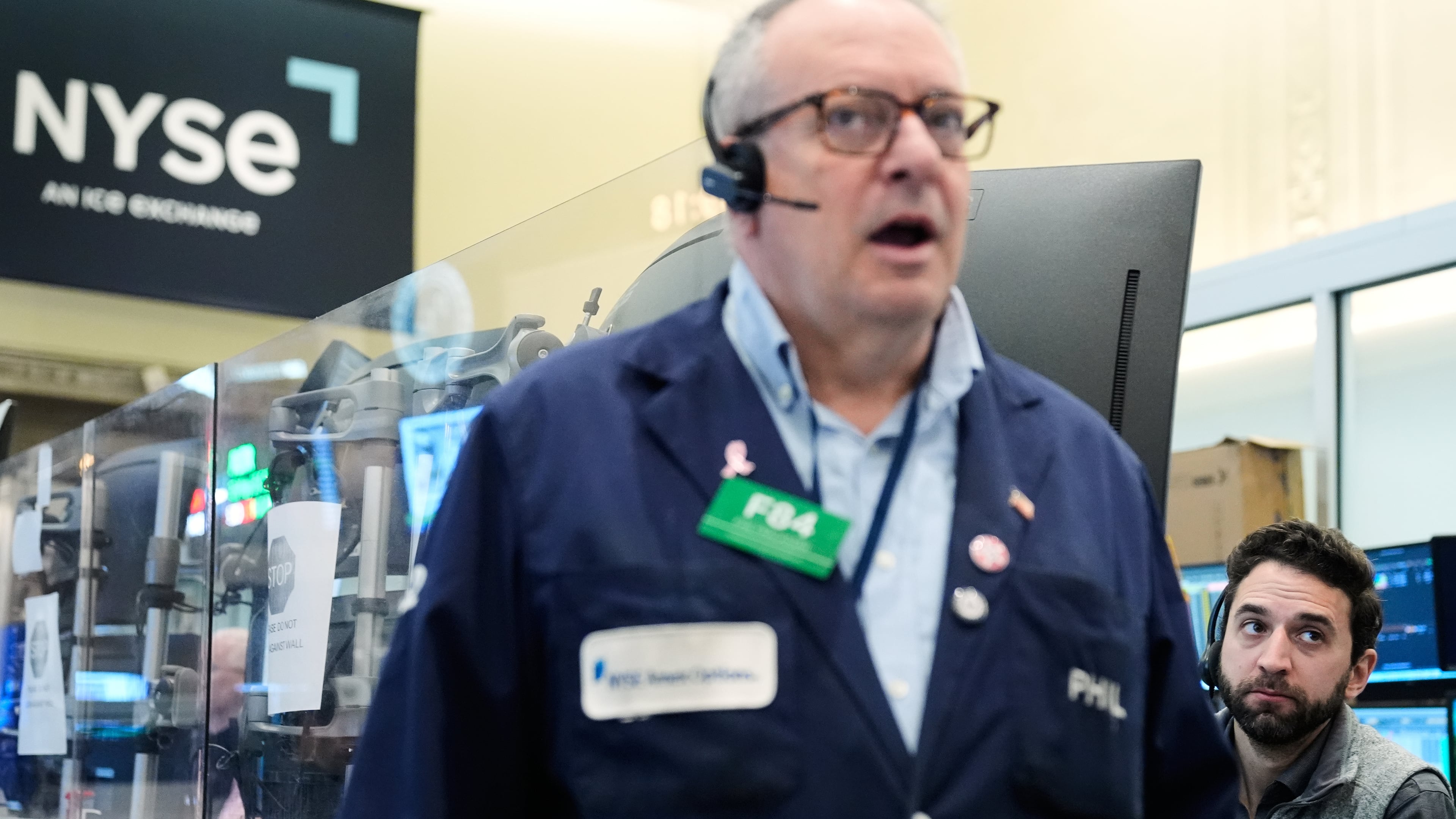 People work on the floor at the New York Stock Exchange in New York, Monday, April 13, 2026. (AP Photo/Seth Wenig)