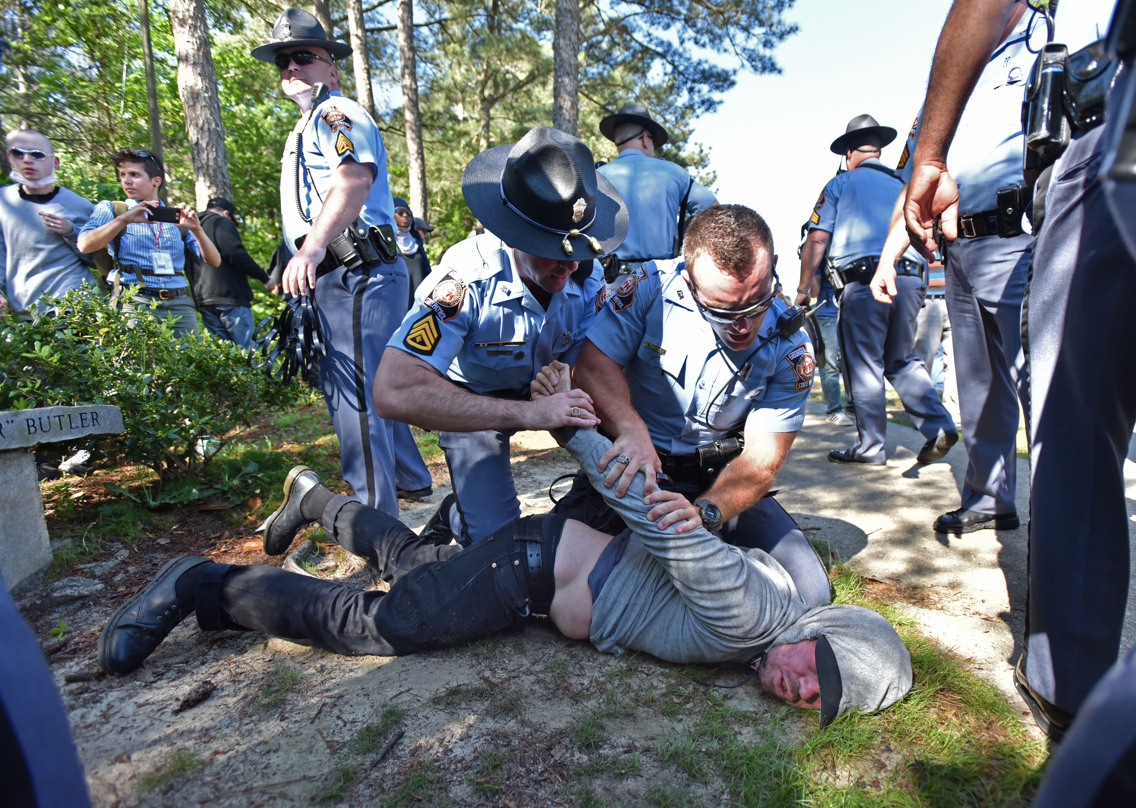 A counter-protester is arrested by police as they try to get past police and to a white power protest at Stone Mountain Park on Saturday, April 23, 2016.