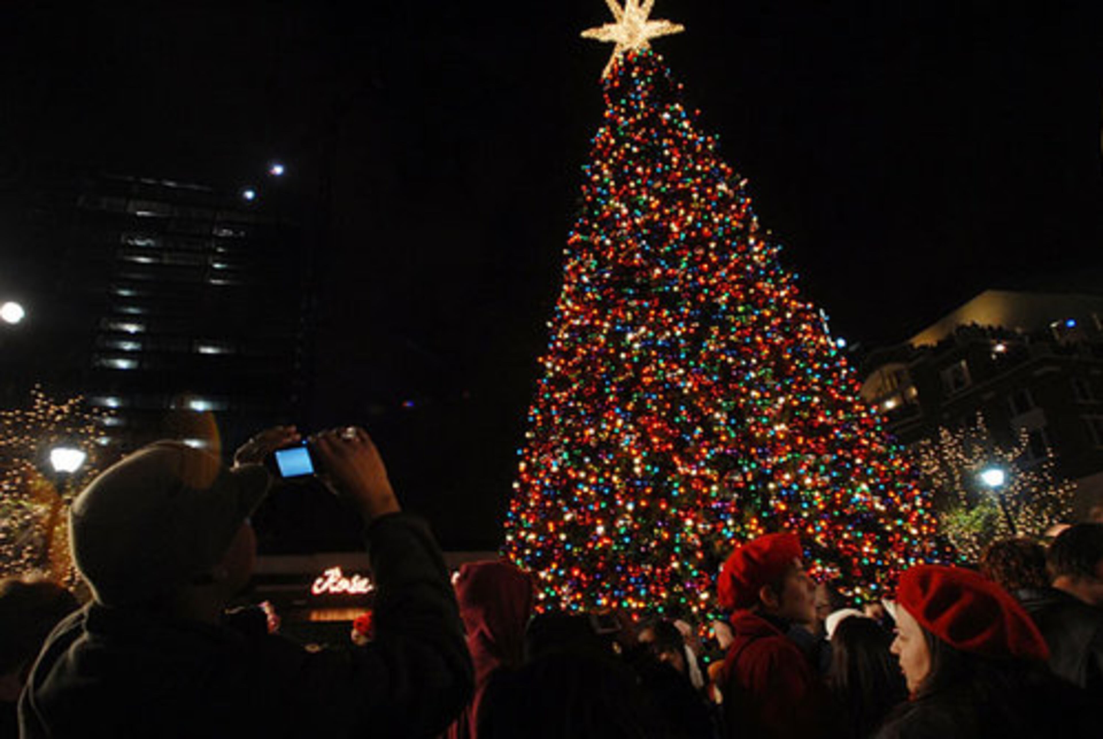 Hundreds of people turned out for the fourth annual Christmas tree lighting ceremony at Atlantic Station. Here, Jahmal Harris, of Atlanta, takes a digital picture of the newly lit tree.