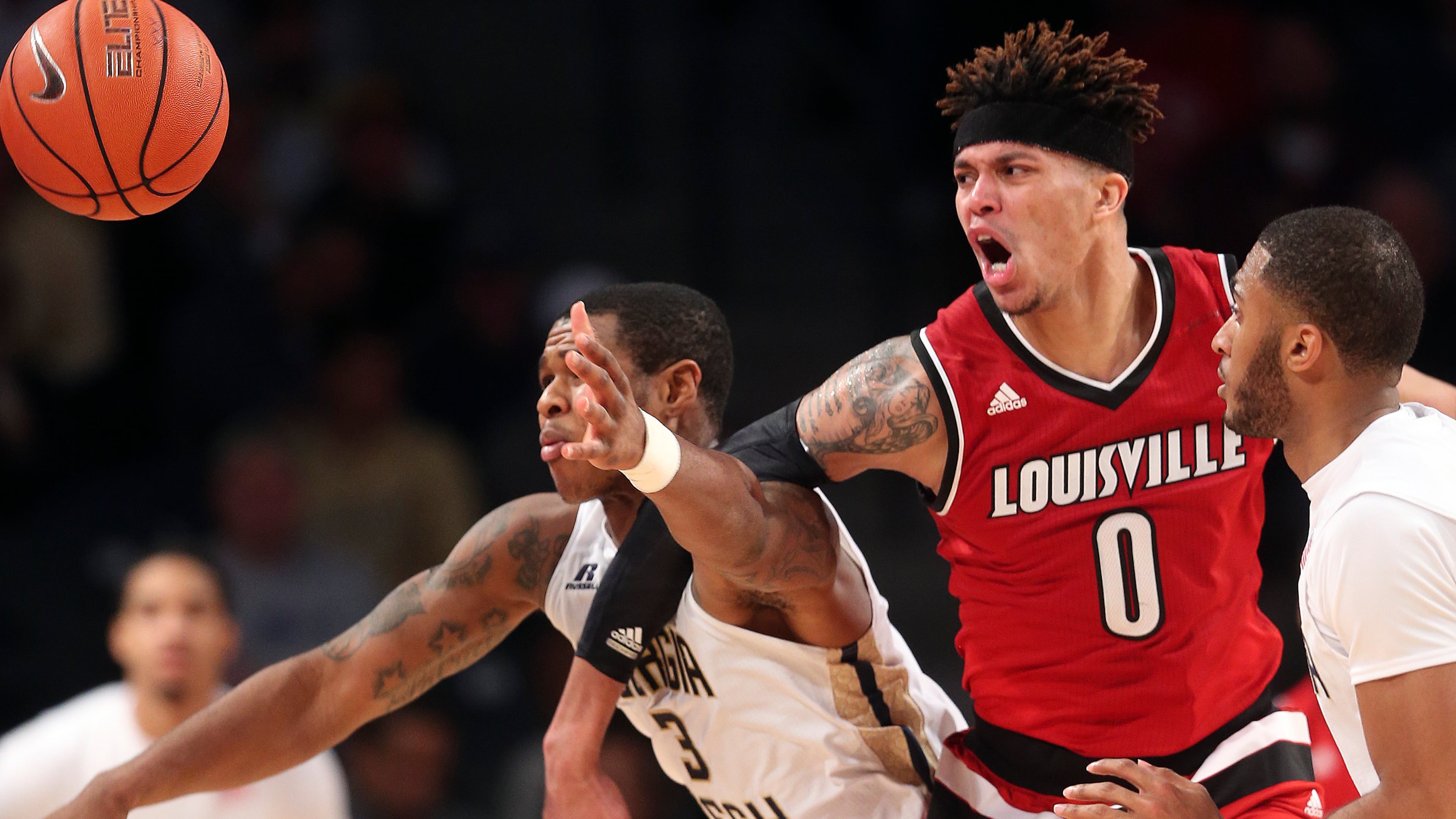Louisville guard Damion Lee (0) and Georgia Tech guard Marcus Georges-Hunt (3) chase a loose ball in the second half of an NCAA college basketball game Saturday, Jan. 23, 2016, in Atlanta. Louisville won 75-71. (AP Photo/John Bazemore)