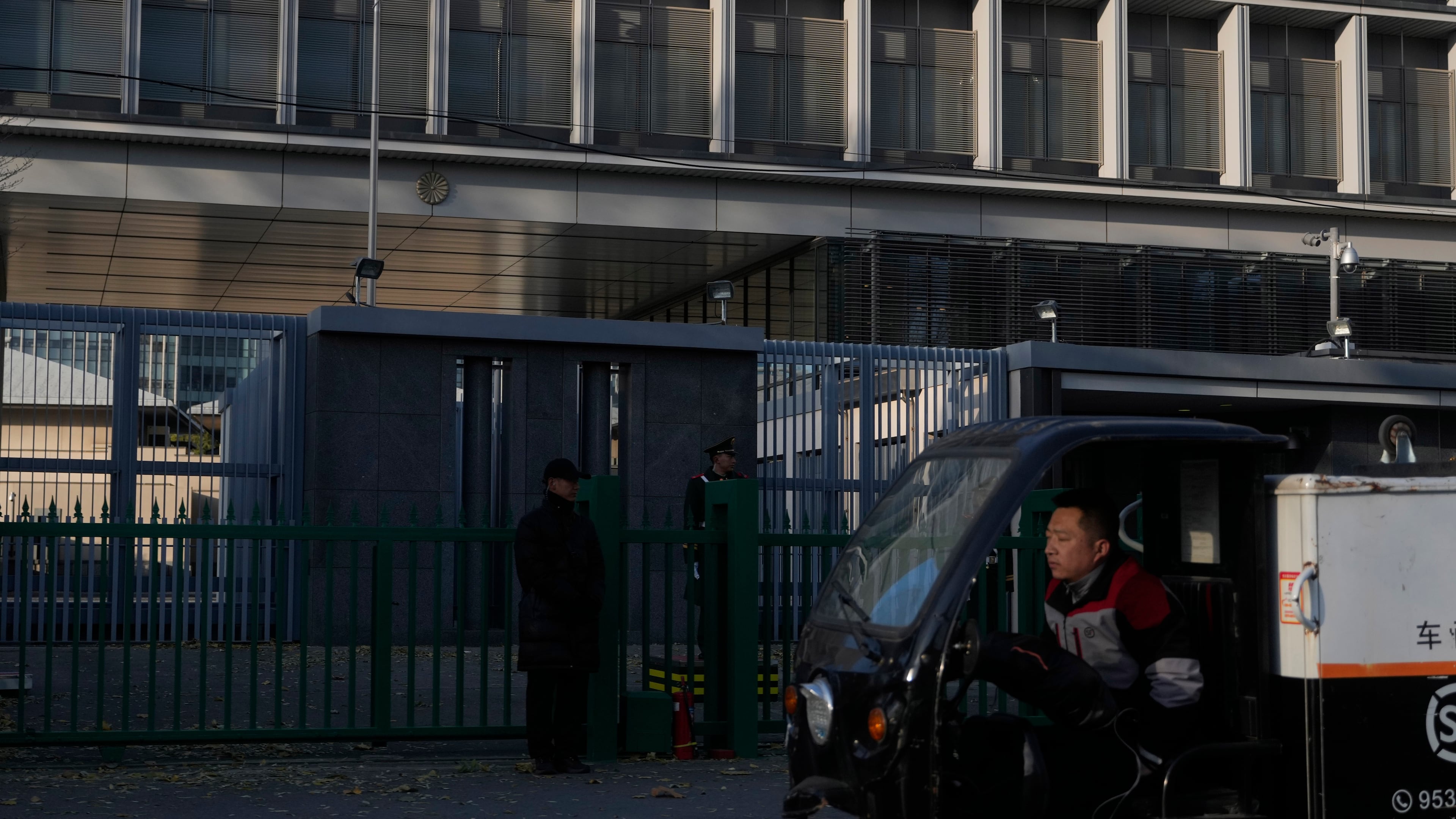 A delivery man drives past the Japanese Embassy in Beijing on Nov. 24, 2025. (AP Photo/Ng Han Guan)