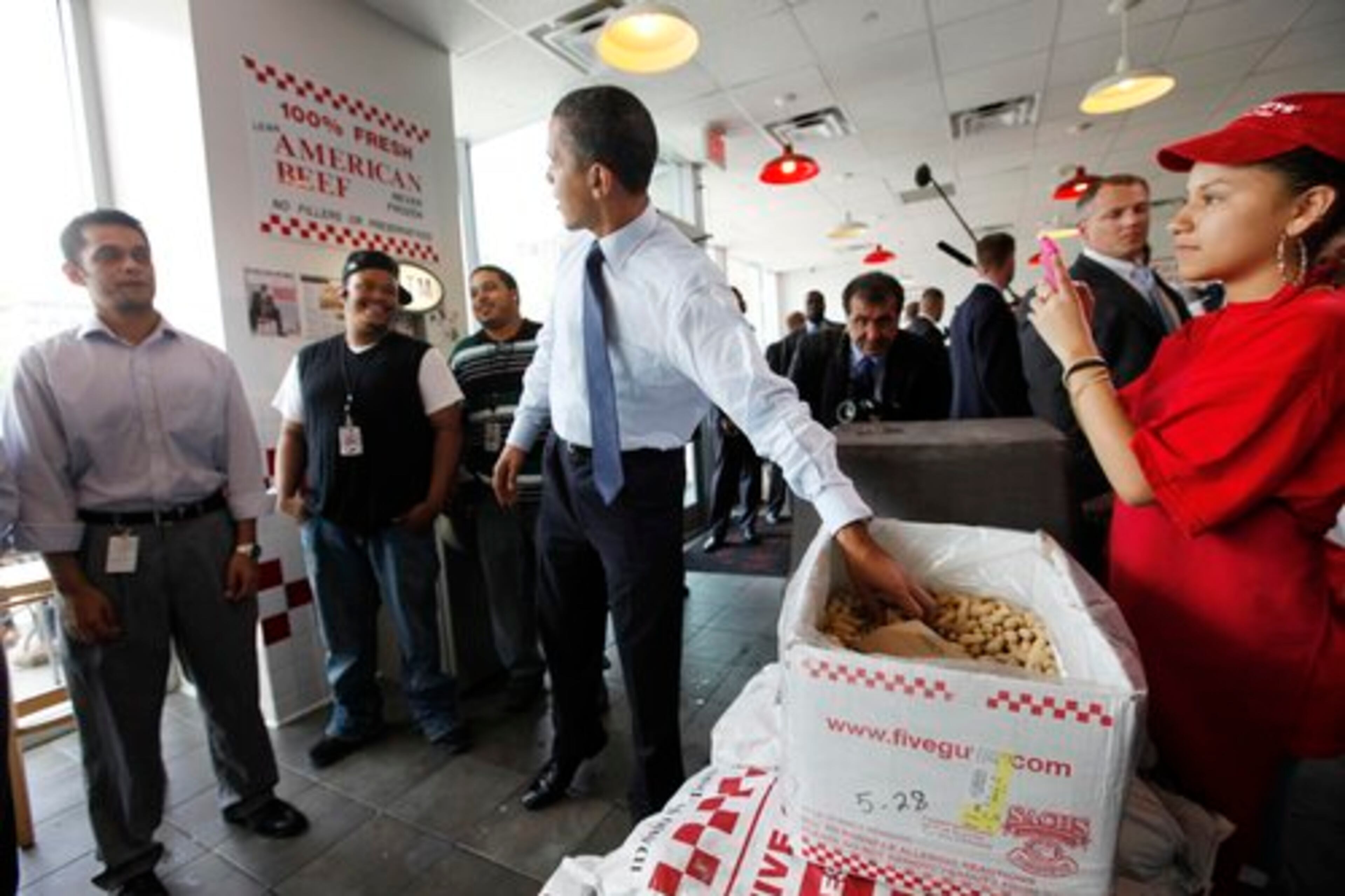 The president snacked on peanuts, and chatted with surprised customers while he waited for his order.