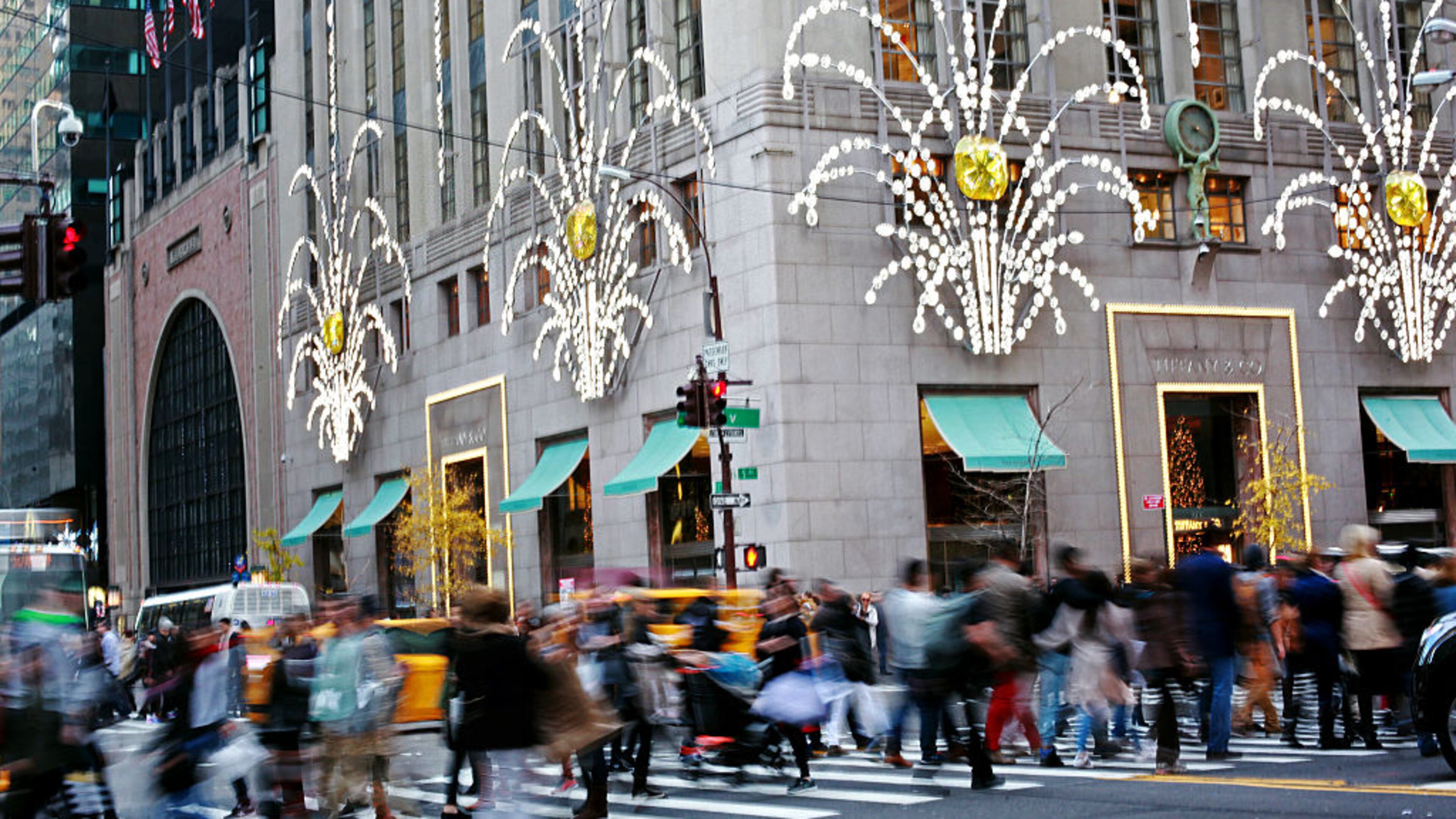 NEW YORK - NOVEMBER 27: Shoppers walk by holiday decor hanging on Tiffany & Co. in New York City on Black Friday, November 27, 2015. Although Black Friday sales are expected to be strong, many shoppers are opting to buy online or retailers are offering year round sales and other incentives that are expected to ease crowds. (Photo by Yana Paskova/Getty Images)