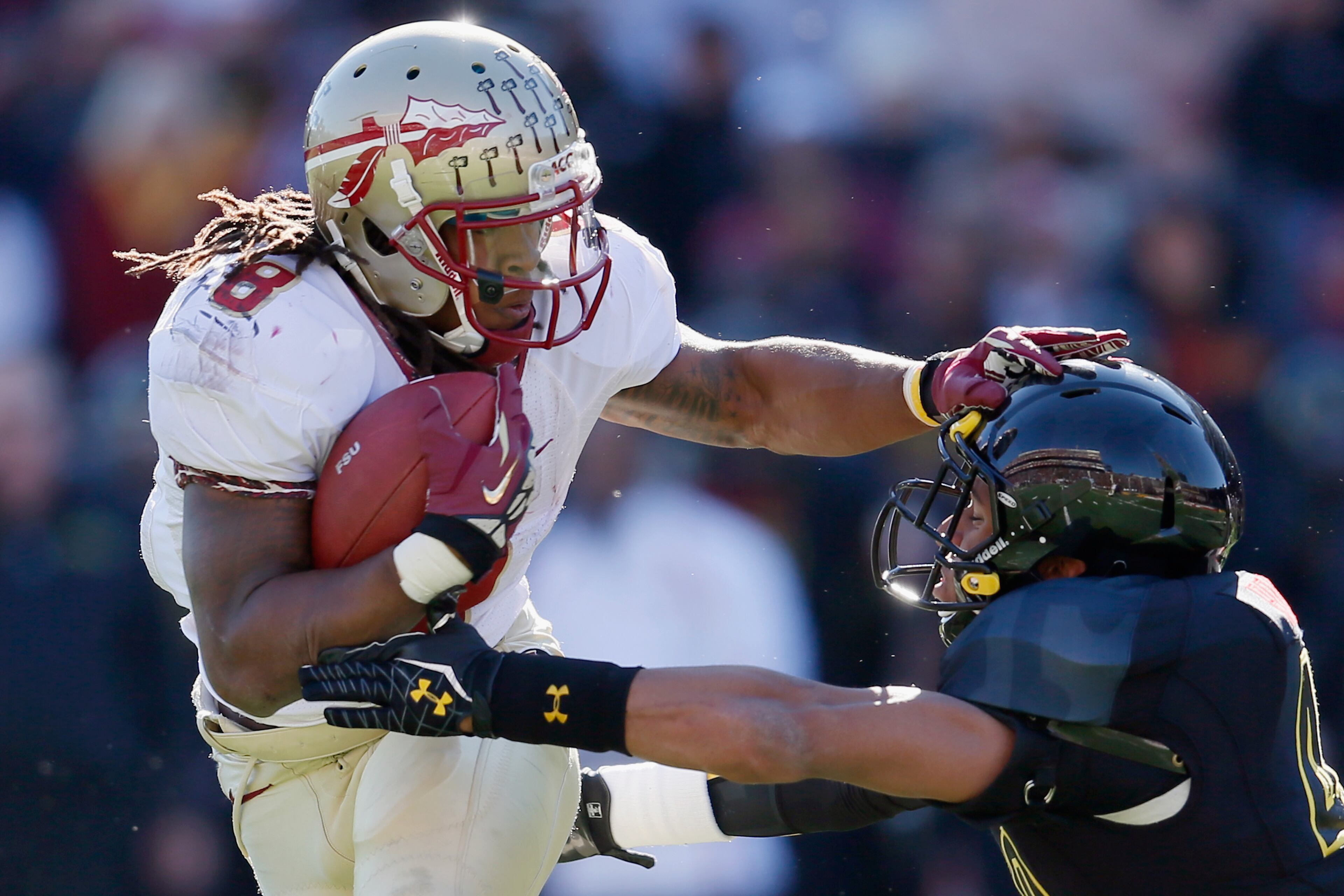 COLLEGE PARK, MD - NOVEMBER 17: Running back Devonta Freeman #8 of the Florida State Seminoles eludes the tackle of defensive back Matt Robinson #40 of the Maryland Terrapins during the first half at Byrd Stadium on November 17, 2012 in College Park, Maryland. (Photo by Rob Carr/Getty Images)