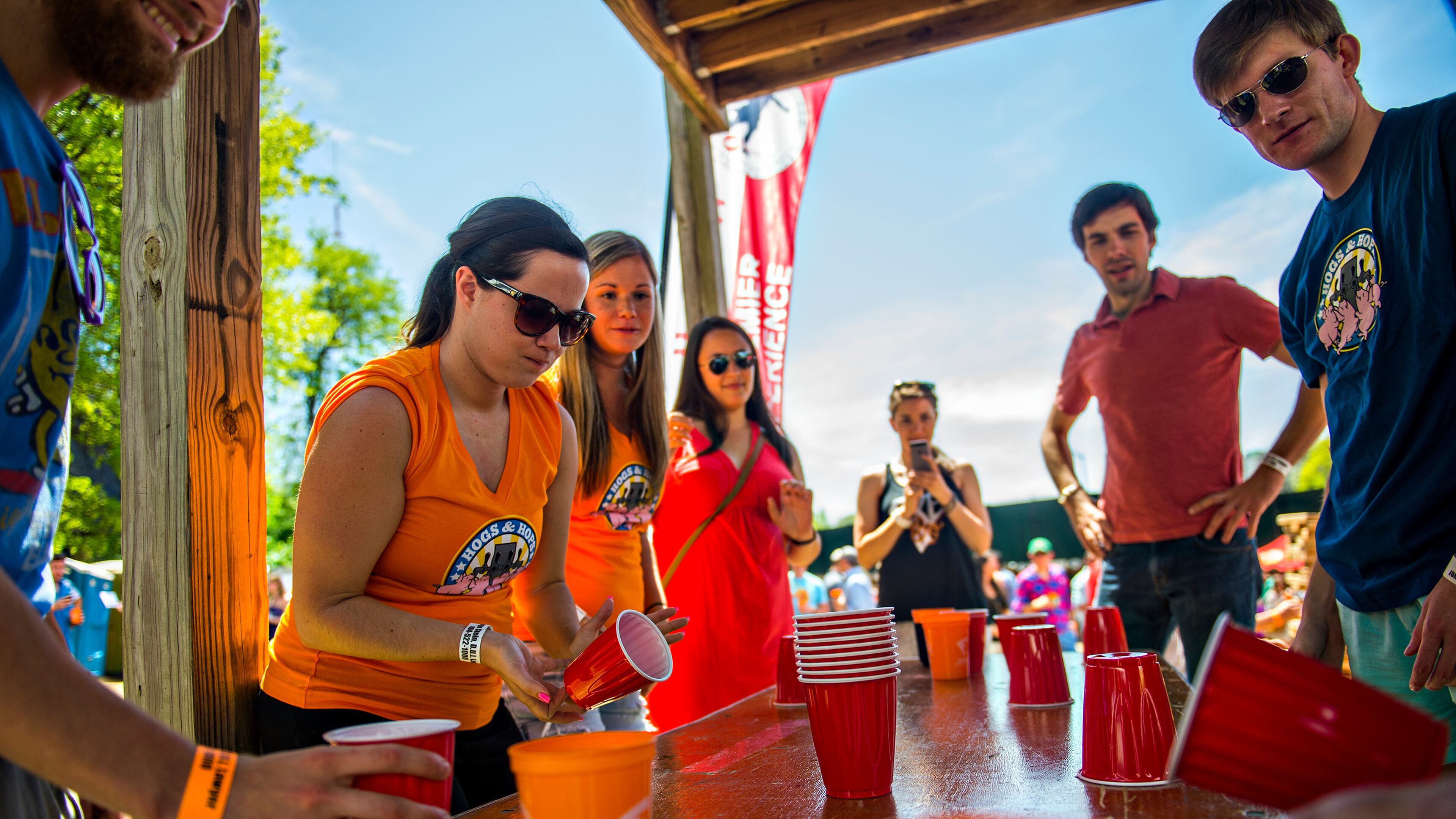 Sarah Gamache (left) plays a game of flip cup during the Hogs & Hops Festival at The Masquerade in Atlanta on Saturday, April 11, 2015. The annual festival featured beer and barbeque as well as live music and games. JONATHAN PHILLIPS / SPECIAL