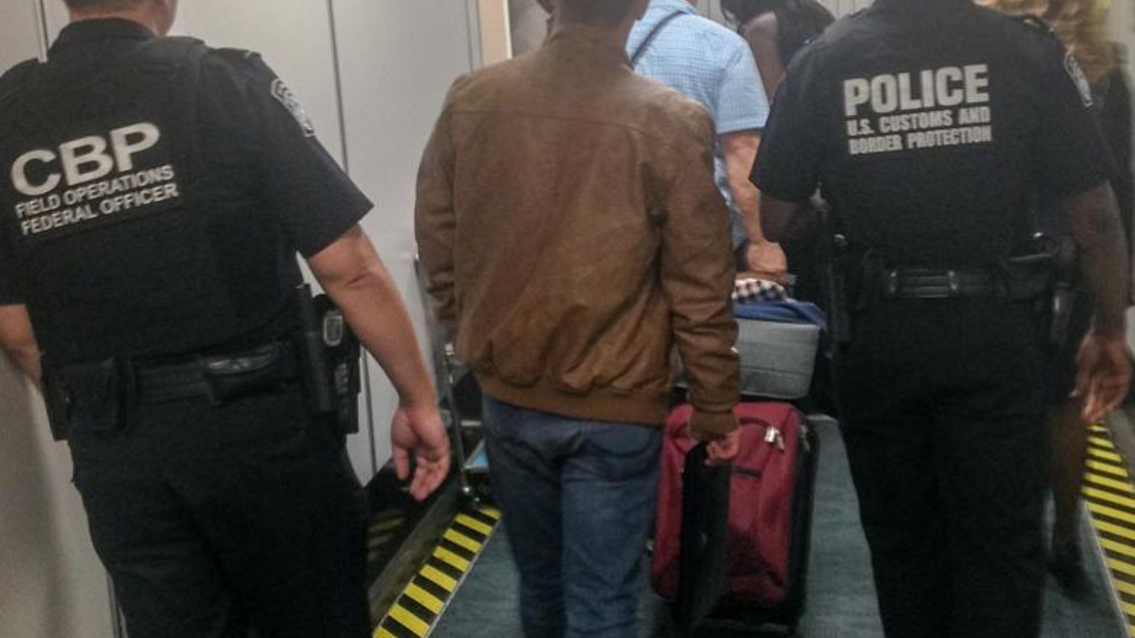 Atlanta U.S. Customs and Border Protection agents escort Gentian Kurdina, 23, after the Albanian national deserted his cruise ship in Louisiana and boarded a train bound for New York City.