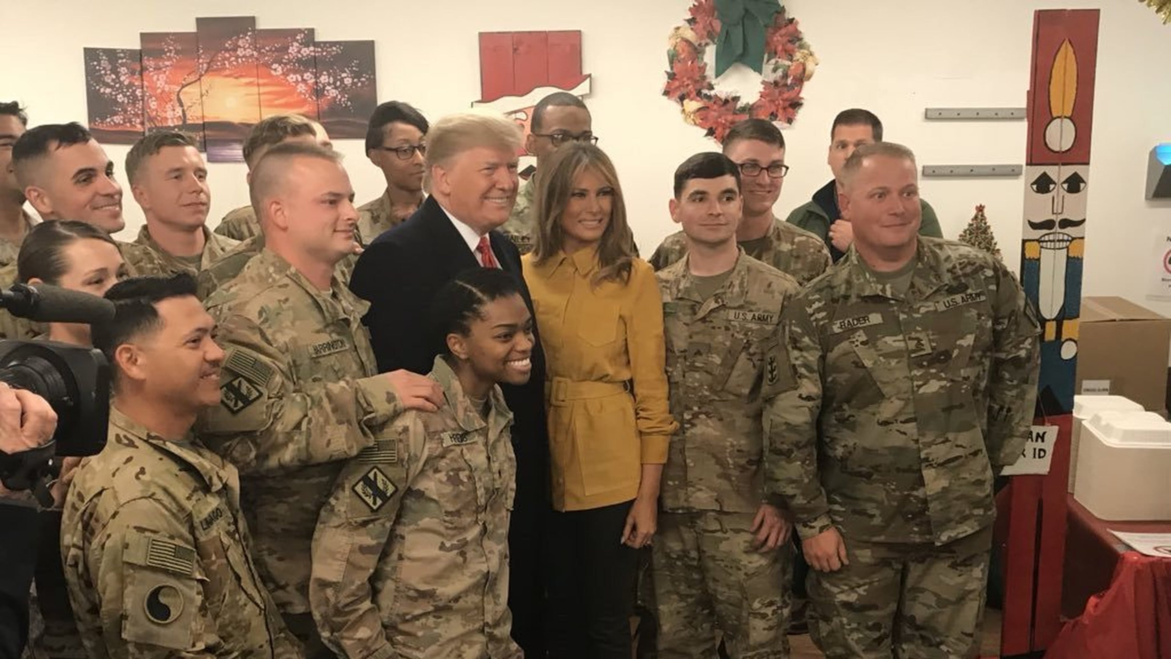 Wednesday, Dec. 26, 2018 — President Donald Trump and first lady Melania Trump pose for a photo with troops during a surprise Christmas visit to Iraq. Among the crowd are Georgia National Guardsmen Paul Harrington of Dallas (to the left of the president) and Matthew Newman of Dalton (third from the right, wearing glasses). Photo provided by The White House