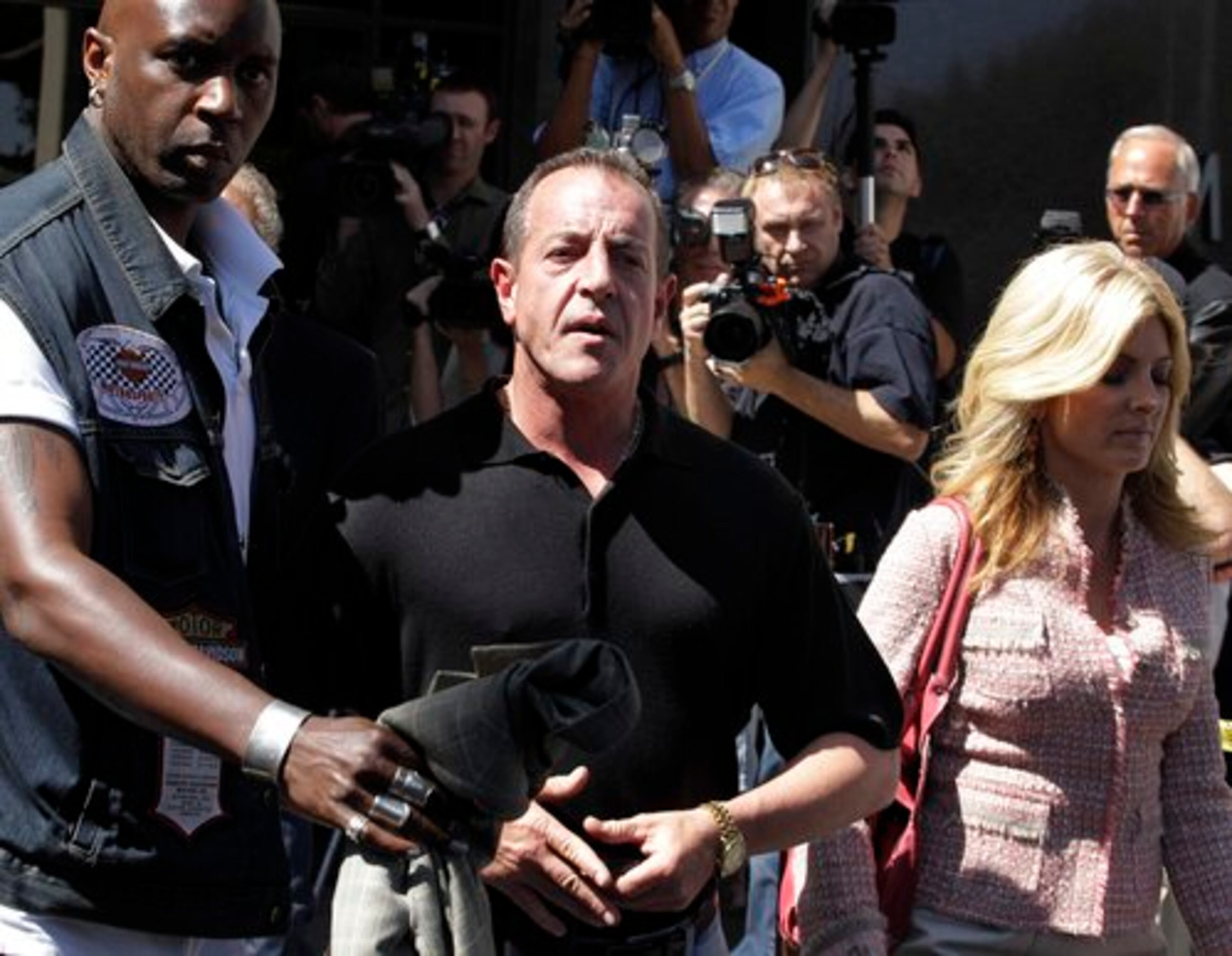 Michael Lohan, center, father of Lindsay Lohan, and his lawyer Lisa Bloom, right, leave Beverly Hills courthouse.