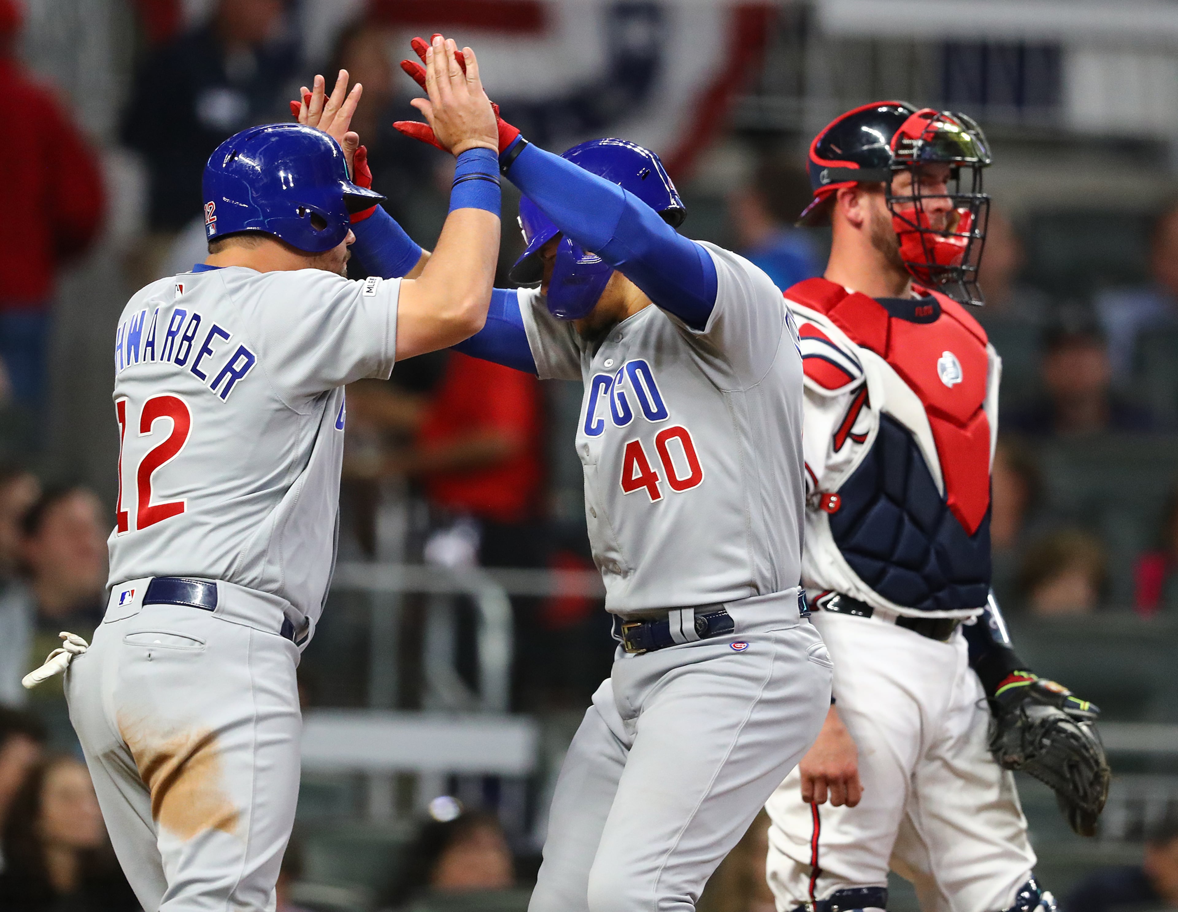 Willson Contreras (middle) of the Cubs gets five from Kyle Schwarber. Curtis Compton/ccompton@ajc.com