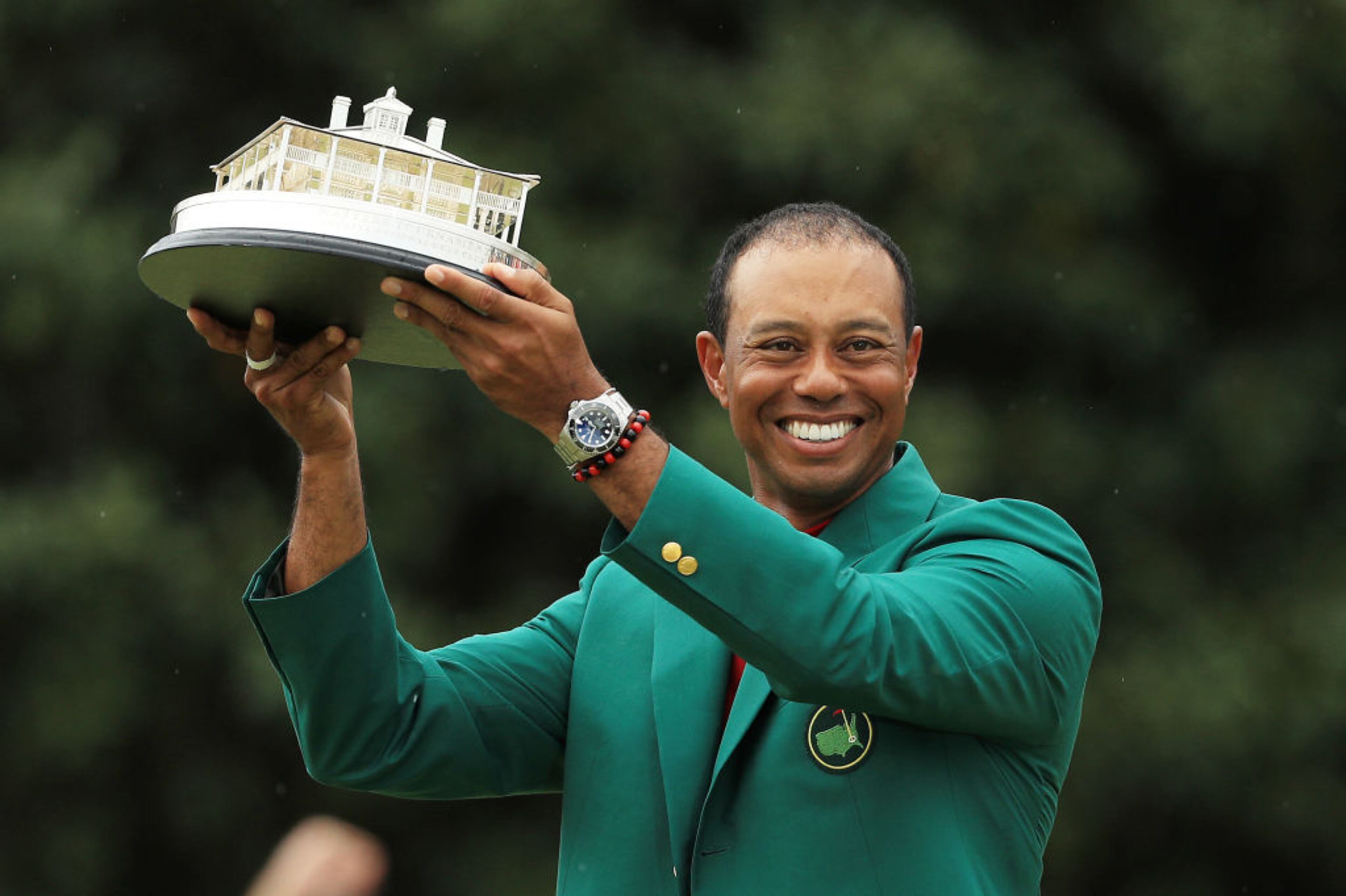 AUGUSTA, GEORGIA - APRIL 14: Tiger Woods of the United States celebrates with the Masters Trophy during the Green Jacket Ceremony after winning the Masters at Augusta National Golf Club on April 14, 2019 in Augusta, Georgia. (Photo by Mike Ehrmann/Getty Images)