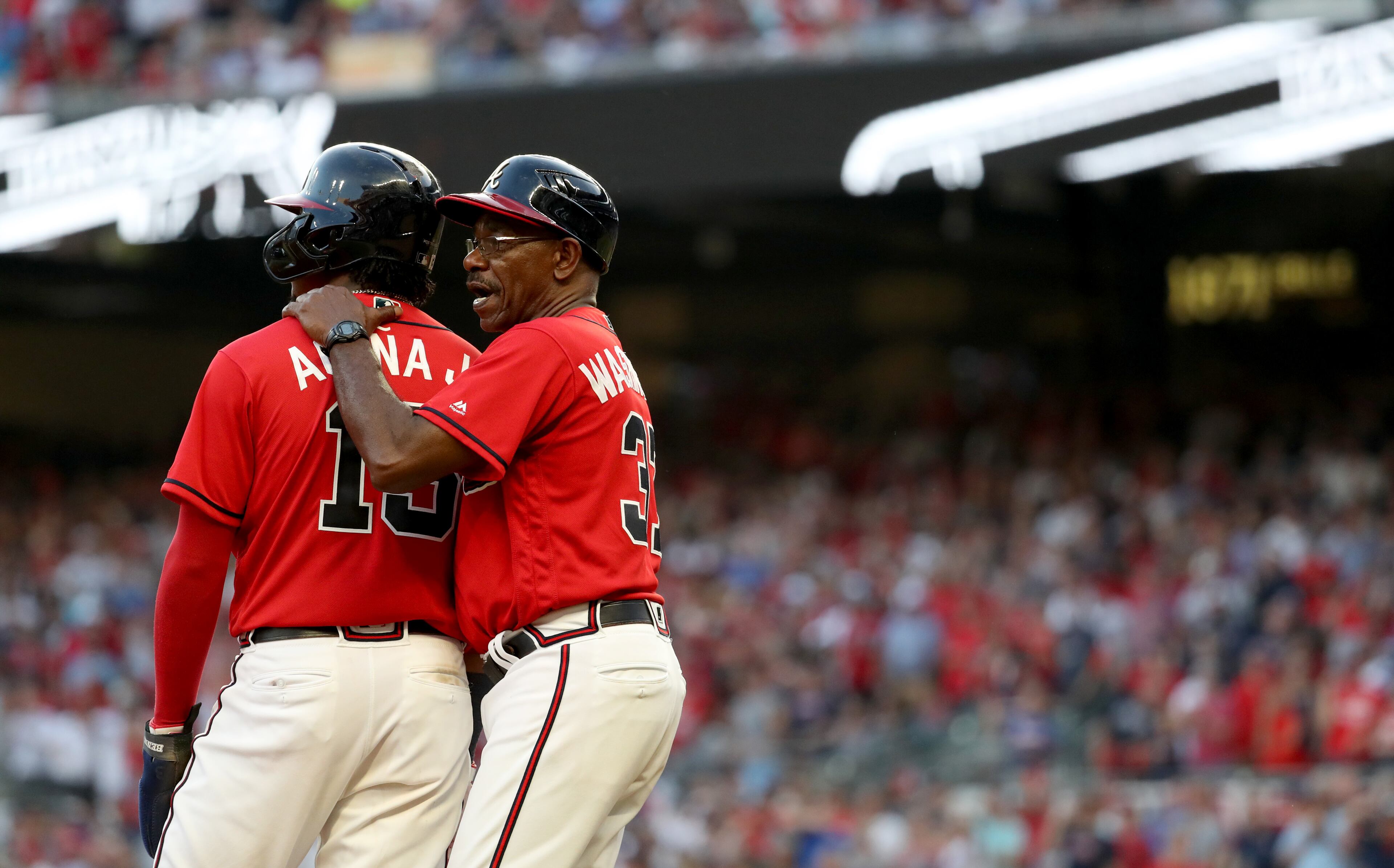 Braves third base coach Ron Washington (37) talks with center fielder Ronald Acuna. (JASON GETZ/SPECIAL TO THE AJC)