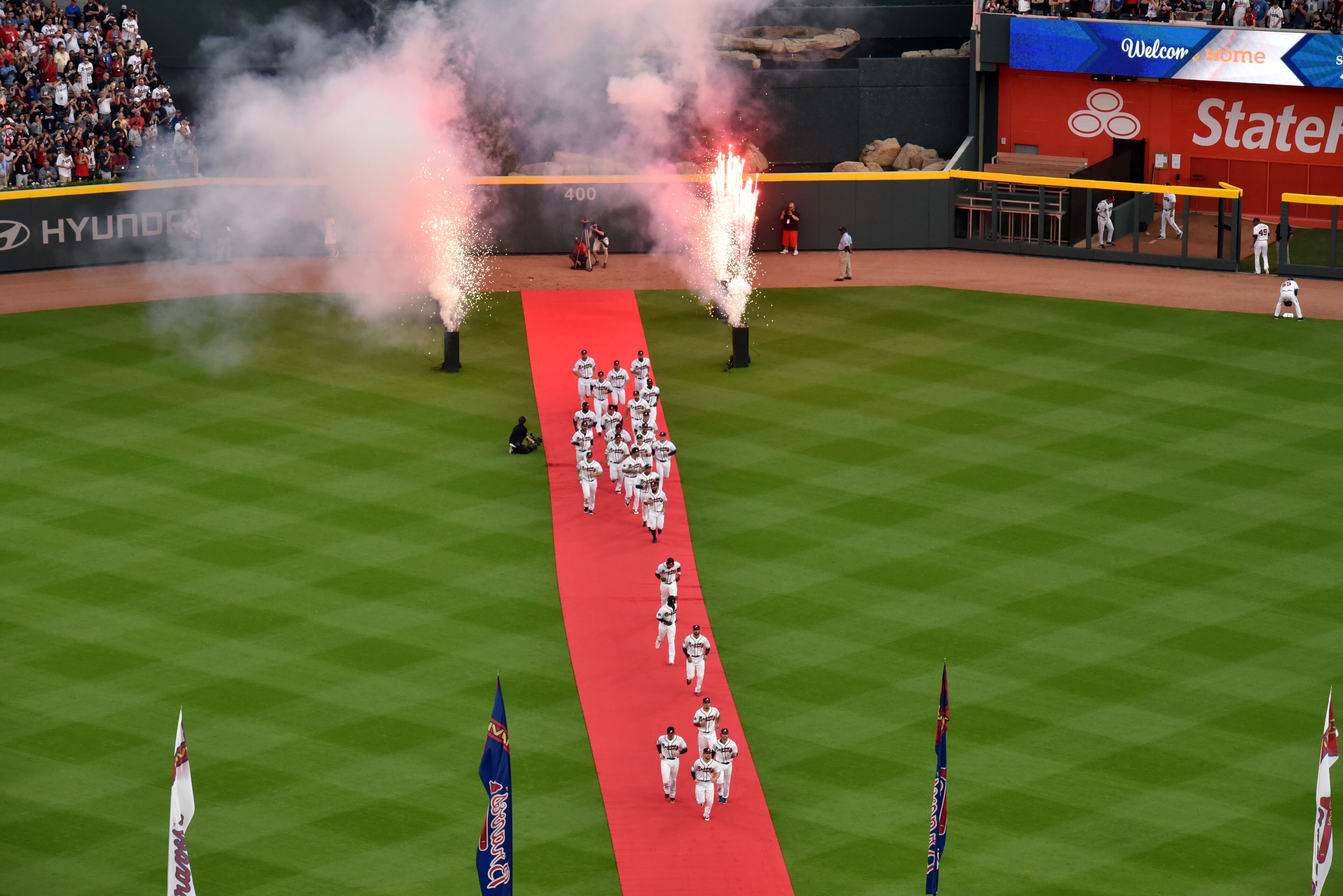 Braves players run onto the field before they play the San Diego Padres in the season opener in the new SunTrust Park Friday, April 14, 2017.