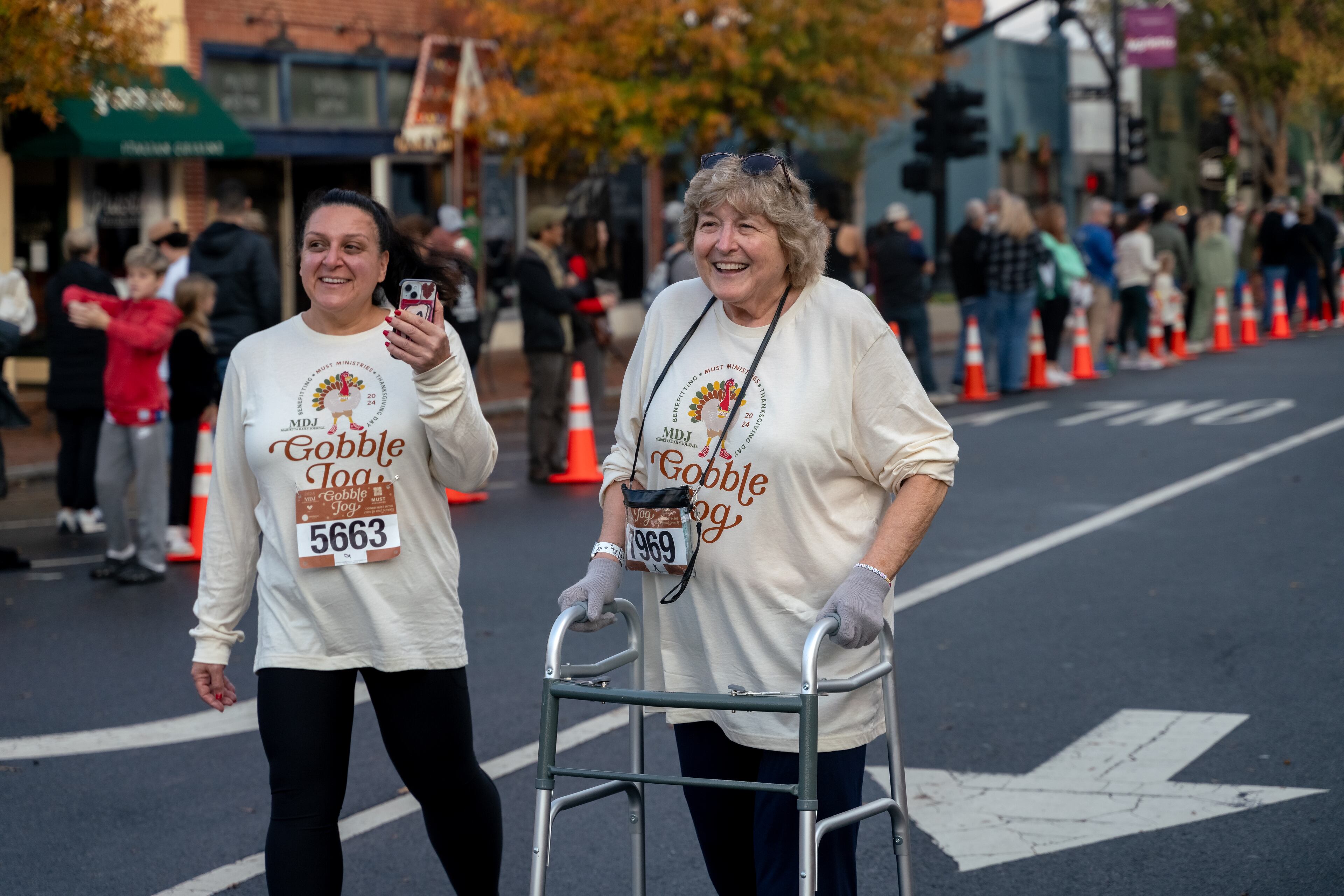 Ellen Silver, 77, and her daughter Wendy Burr finish the 10k race. Hundreds gather to run in various races at the 2024 Gobble Jog in downtown Marietta, Georgia. Thursday, November 28, 2024 (Ben Hendren for the Atlanta Journal-Constitution)