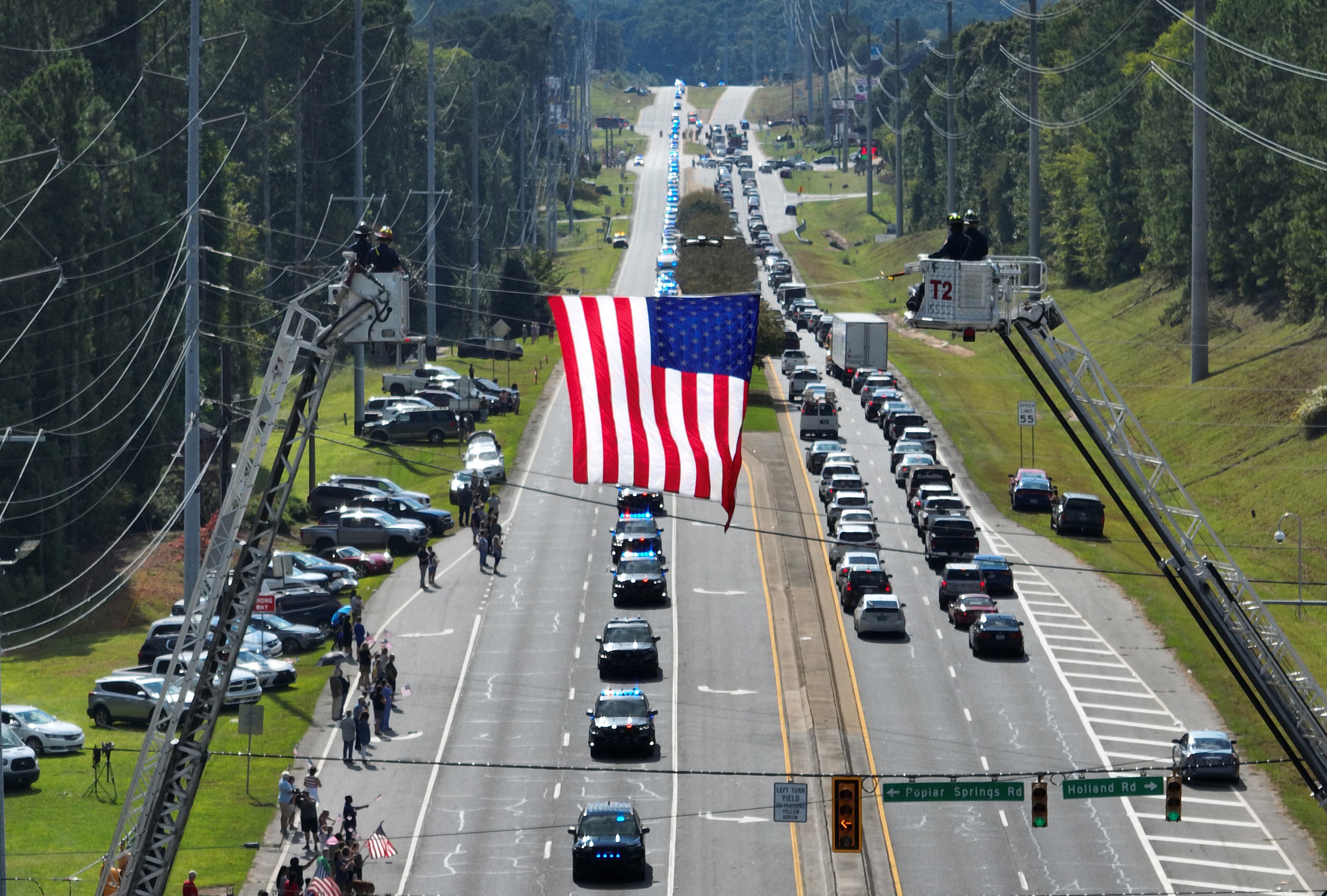 September 15, 2022 Dallas - Aerial photograph shows the funeral procession of Deputy Marshall Samuel Ervin Jr. on Dallas Highway in Dallas on Thursday, September 15, 2022. Law enforcement and community members honor Deputy Marshall Samuel Ervin Jr., who was killed in the line of duty. (Hyosub Shin / Hyosub.Shin@ajc.com)