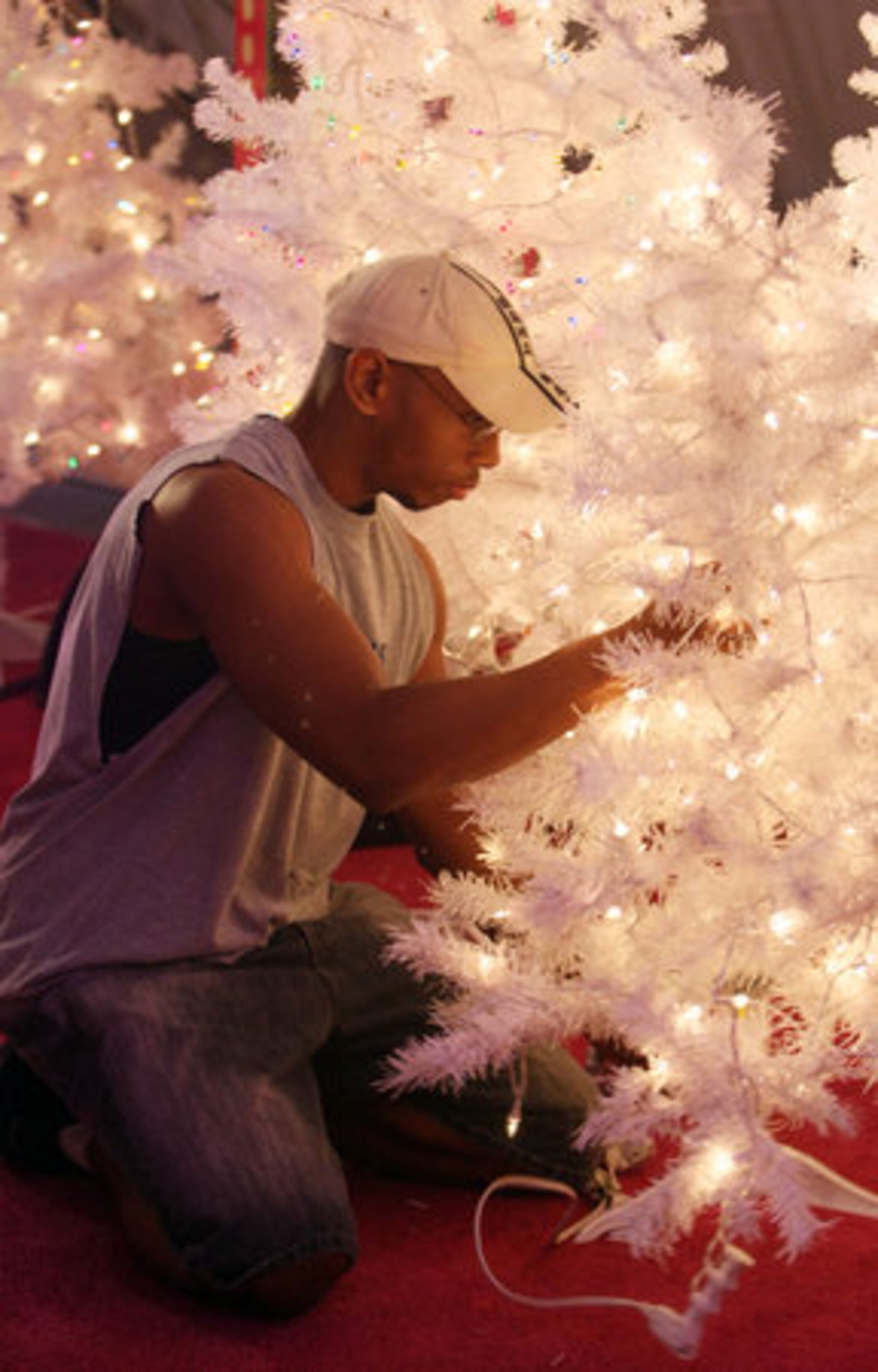 Jonathan Whitehead checks to make sure the Christmas tree lights work. The original Pink Pig was located at the old downtown Rich's and cost children 25 cents per ride.