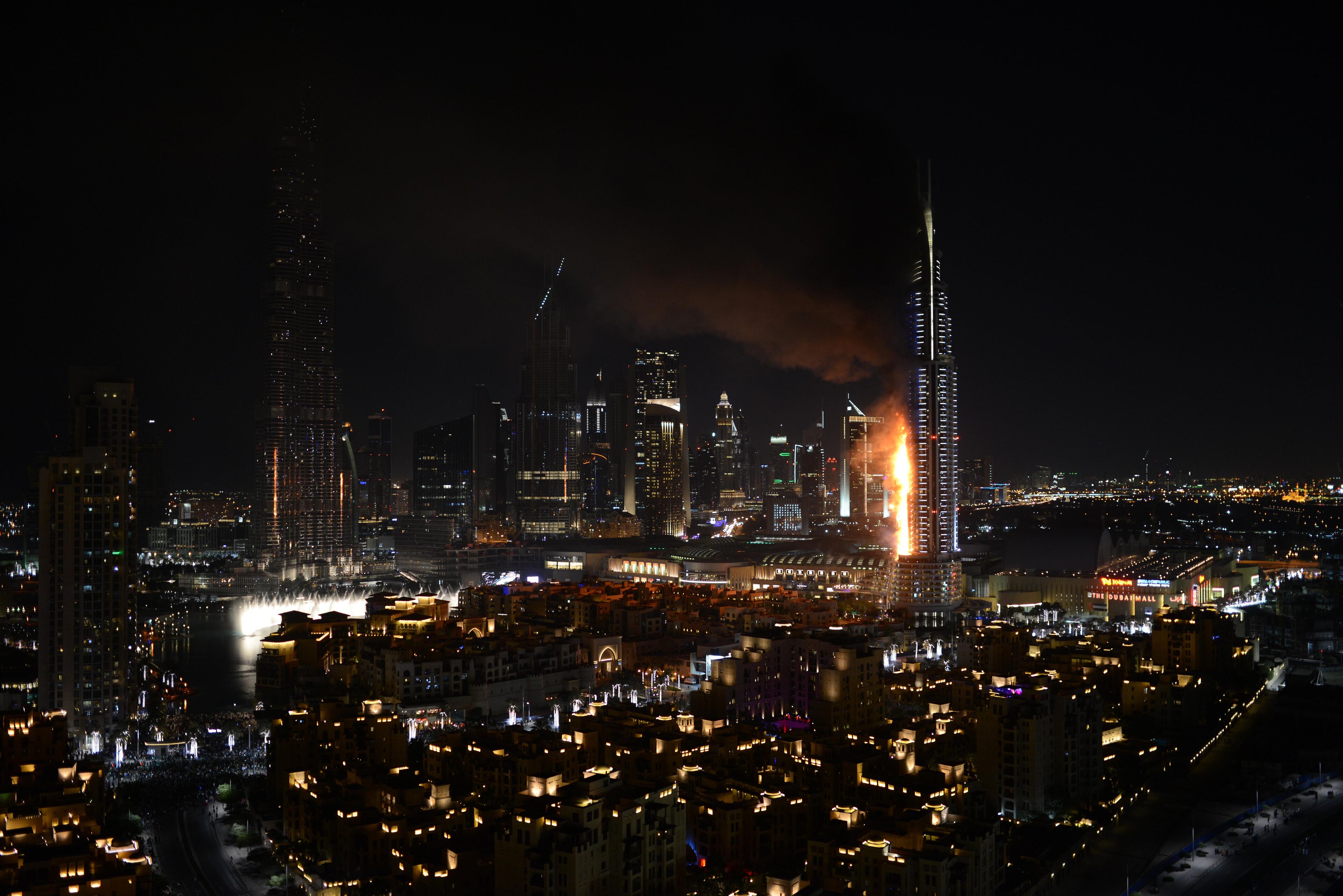 Smoke and flames pouring from a residential building, which also contains the Address Downtown Hotel, in Dubai, United Arab Emirates, Thursday evening, Dec. 31, 2015. (Sina Bahrami/@dearsina via AP) MANDATORY CREDIT