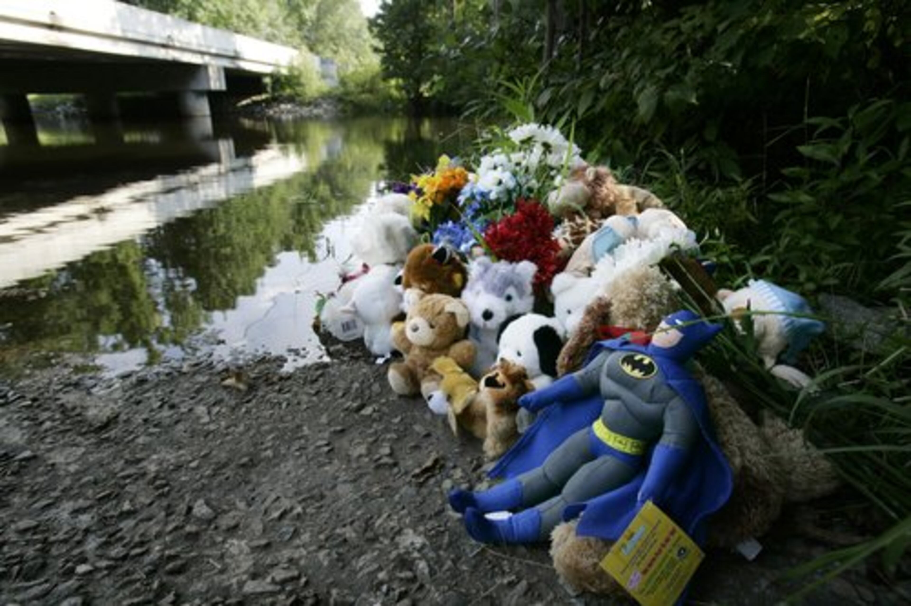 Toys and stuffed dolls are left at a memorial at the Shillings Bridge landing of North Edisto River where the car owned by Shaquan Duley, was found with her two toddlers strapped in their car seats in Orangeburg, S.C.