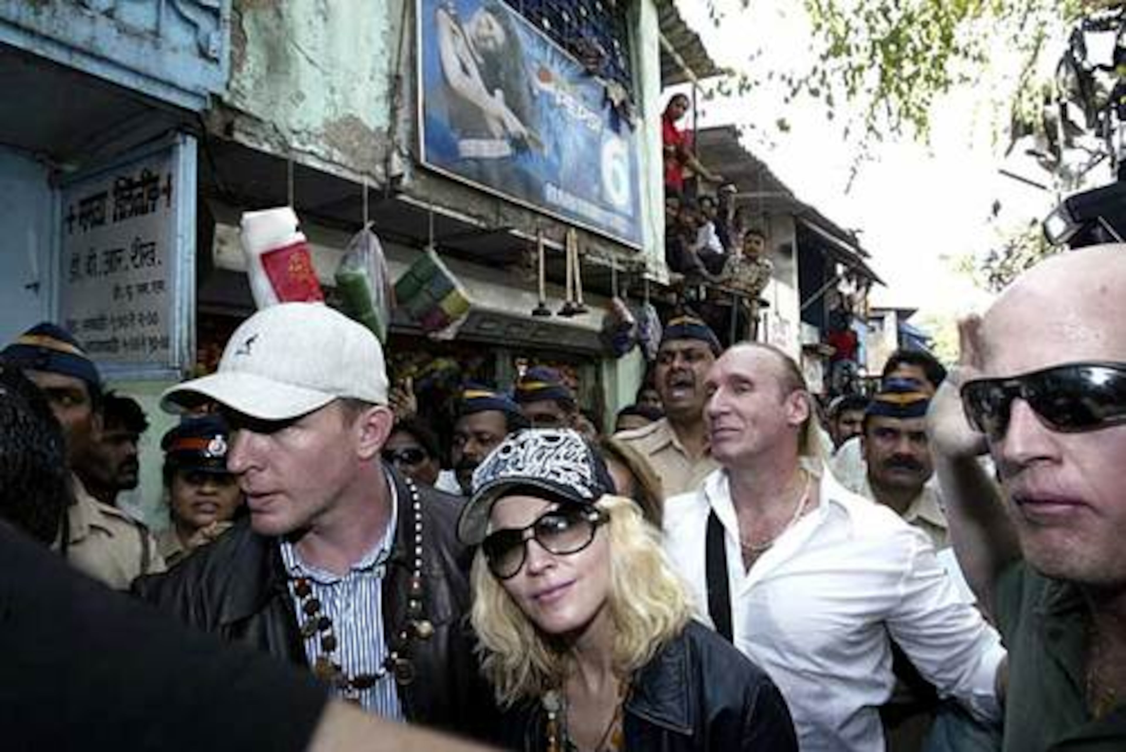 Madonna, Ritchie and Roberts press on through the streets of Mumbai.