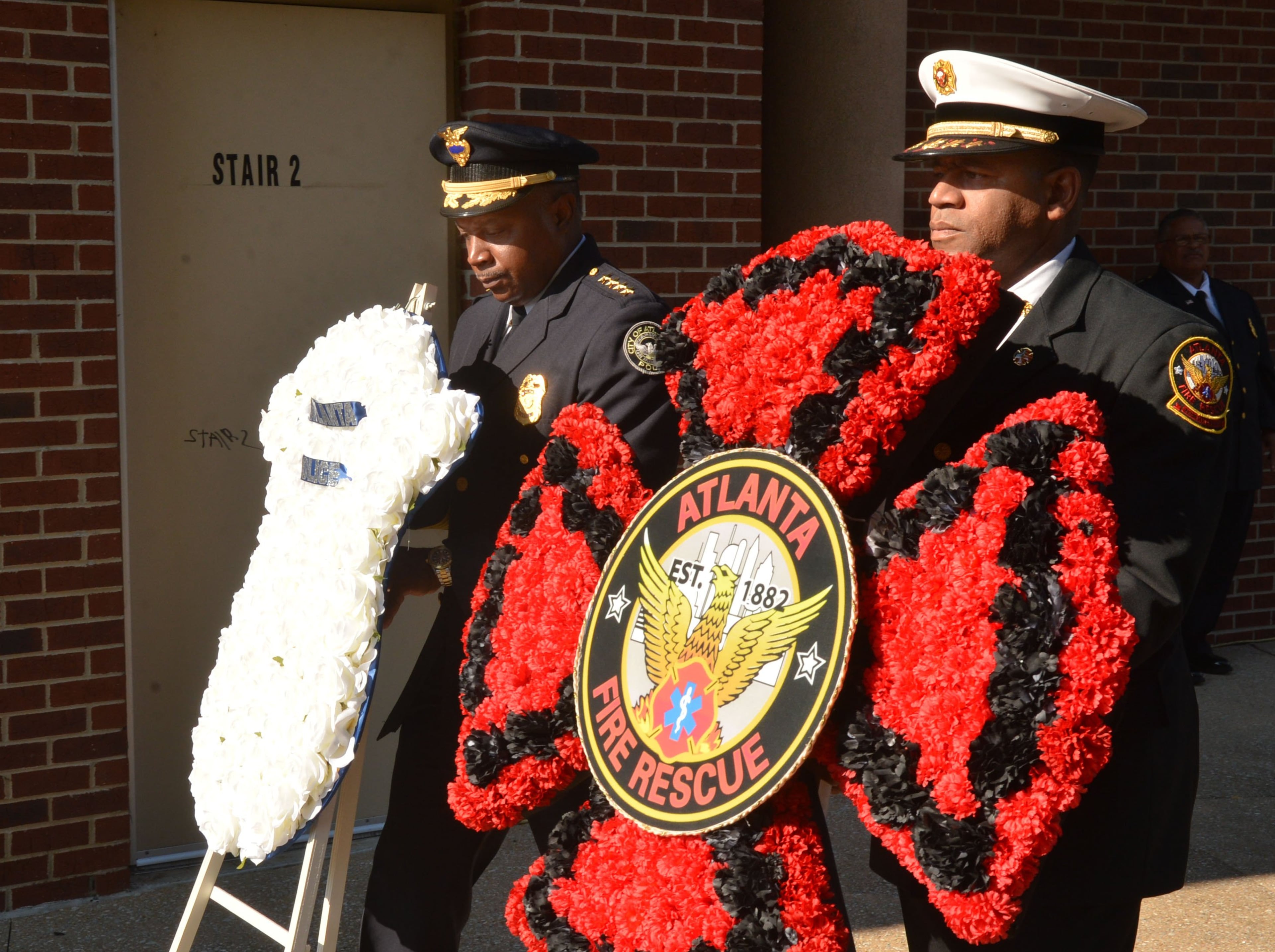 APD Chief George Turner (left) and AFRD Chief Kelvin Cochran place their departmental wreaths. Officials with the Atlanta Police Department and Atlanta Fire Rescue Department honored the 12th anniversary of the Sept. 11, 2001, tragedy during a ceremony at Public Safety Headquarters on Sept. 11, 2013.