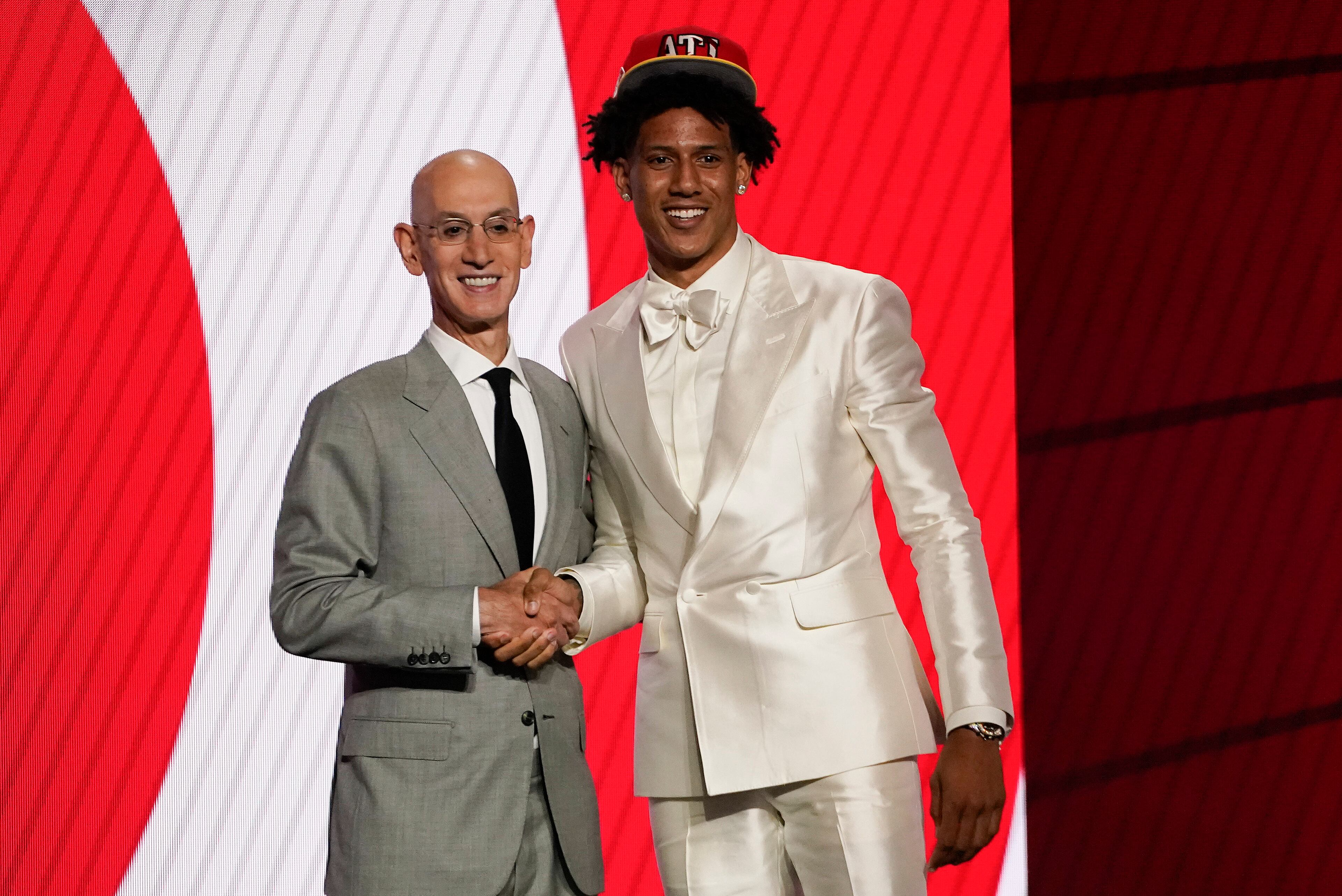 Jalen Johnson, right, poses for a photo with NBA Commissioner Adam Silver after being selected 20th overall by the Atlanta Hawks during the NBA basketball draft, Thursday, July 29, 2021, in New York. (AP Photo/Corey Sipkin)