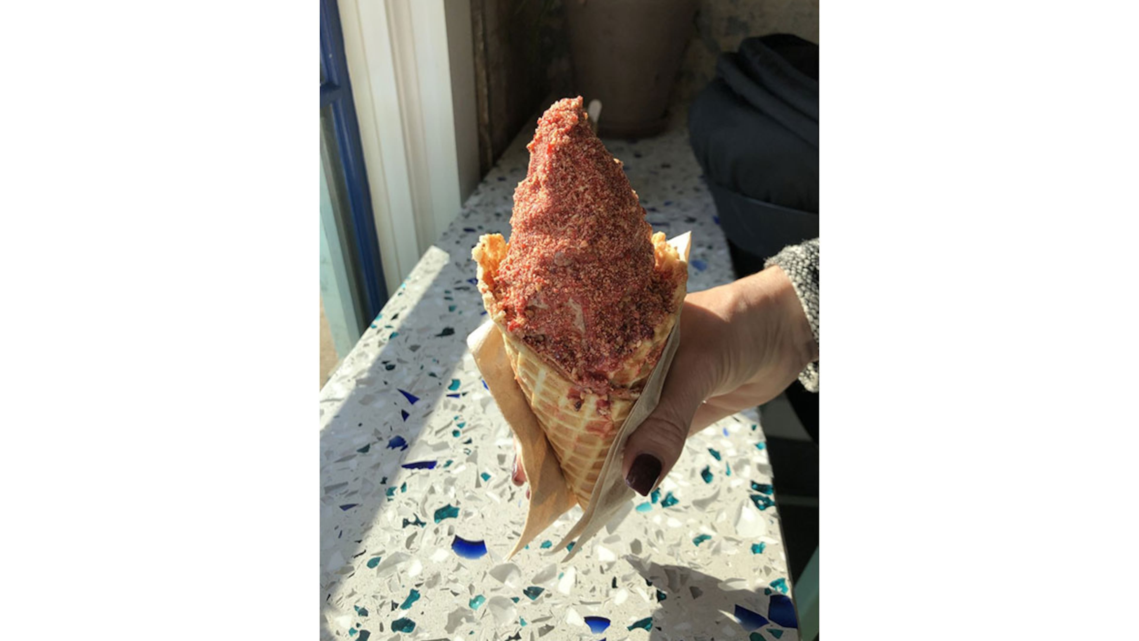 Pretty in pink: Big Softie’s waffle cone is filled with soft serve, coated with a strawberry shell and sprinkled with pink praline. Every component is made in the kitchen shared with sister establishment Little Tart Bakeshop at Summerhill. / CONTRIBUTED BY WENDELL BROCK