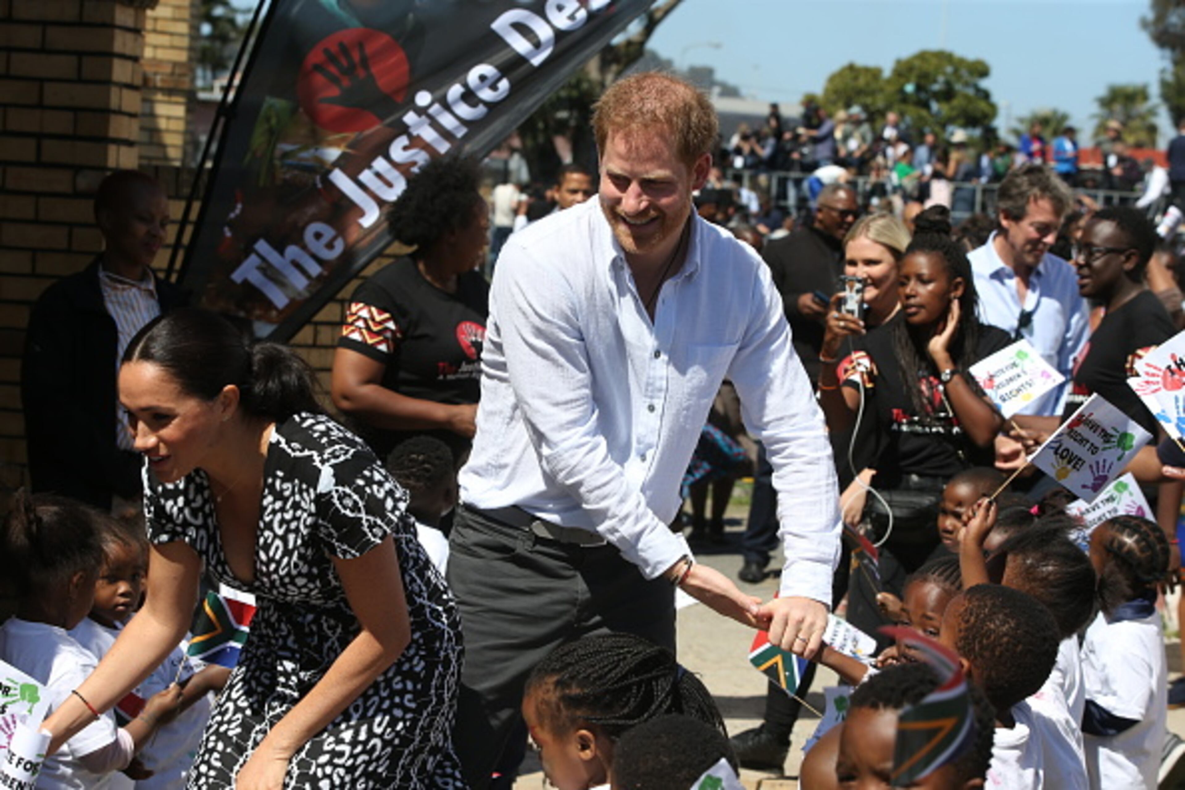 CAPE TOWN, SOUTH AFRICA - SEPTEMBER 23: Meghan, Duchess of Sussex and Prince Harry, Duke of Sussex meet wellwishers during a visit to The Justice Desk on September 30, 2019 in Cape Town, South Africa. The Justice Desk initiative teaches children about their rights and provides self-defence classes and female empowerment training to young girls in the community. (Photo by Ian Vogler - Pool/Getty Images)