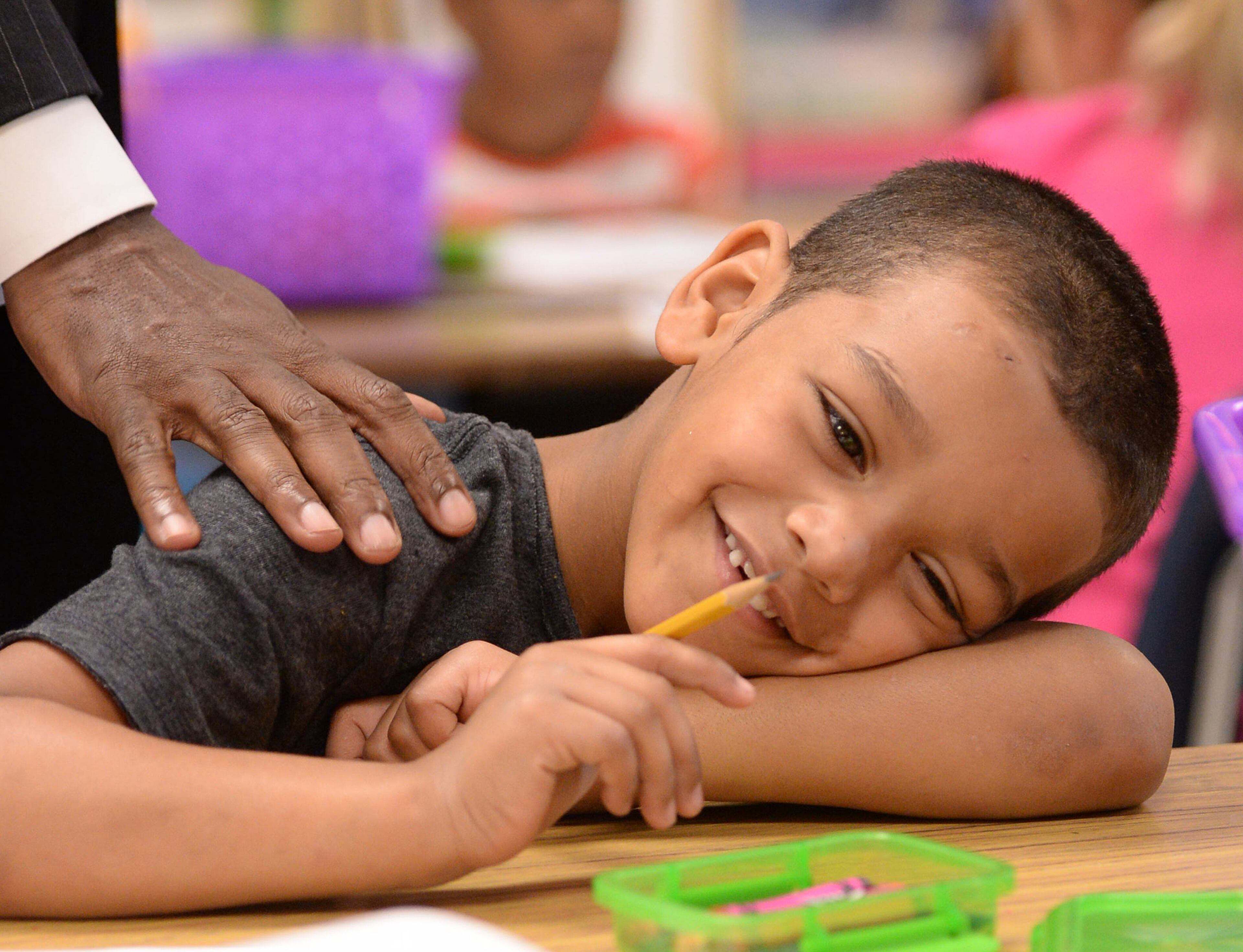 Javan Carter smiles as DeKalb County School District Superintendent Michael Thurmond touches his shoulder on the first day of school inside his first grade class at Midvale Elementary on Monday, August 12, 2013. DeKalb was one of the metro school districts that started school today. JOHNNY CRAWFORD / JCRAWFORD@AJC.COM