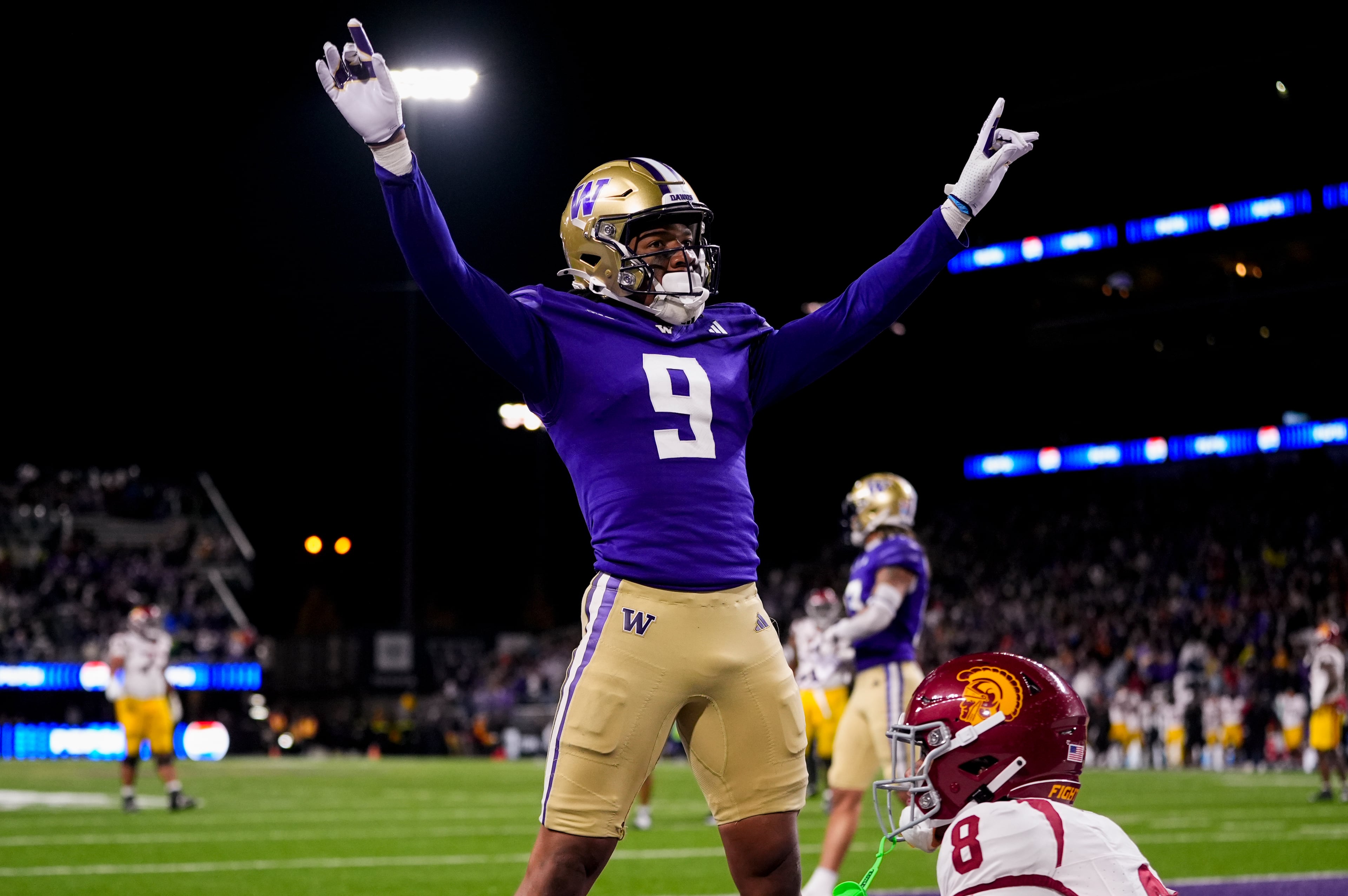 Washington cornerback Thaddeus Dixon celebrates after breaking up a pass to USC wide receiver Ja’Kobi Lane (lower right) during the 2024 season. (Lindsey Wasson/AP)