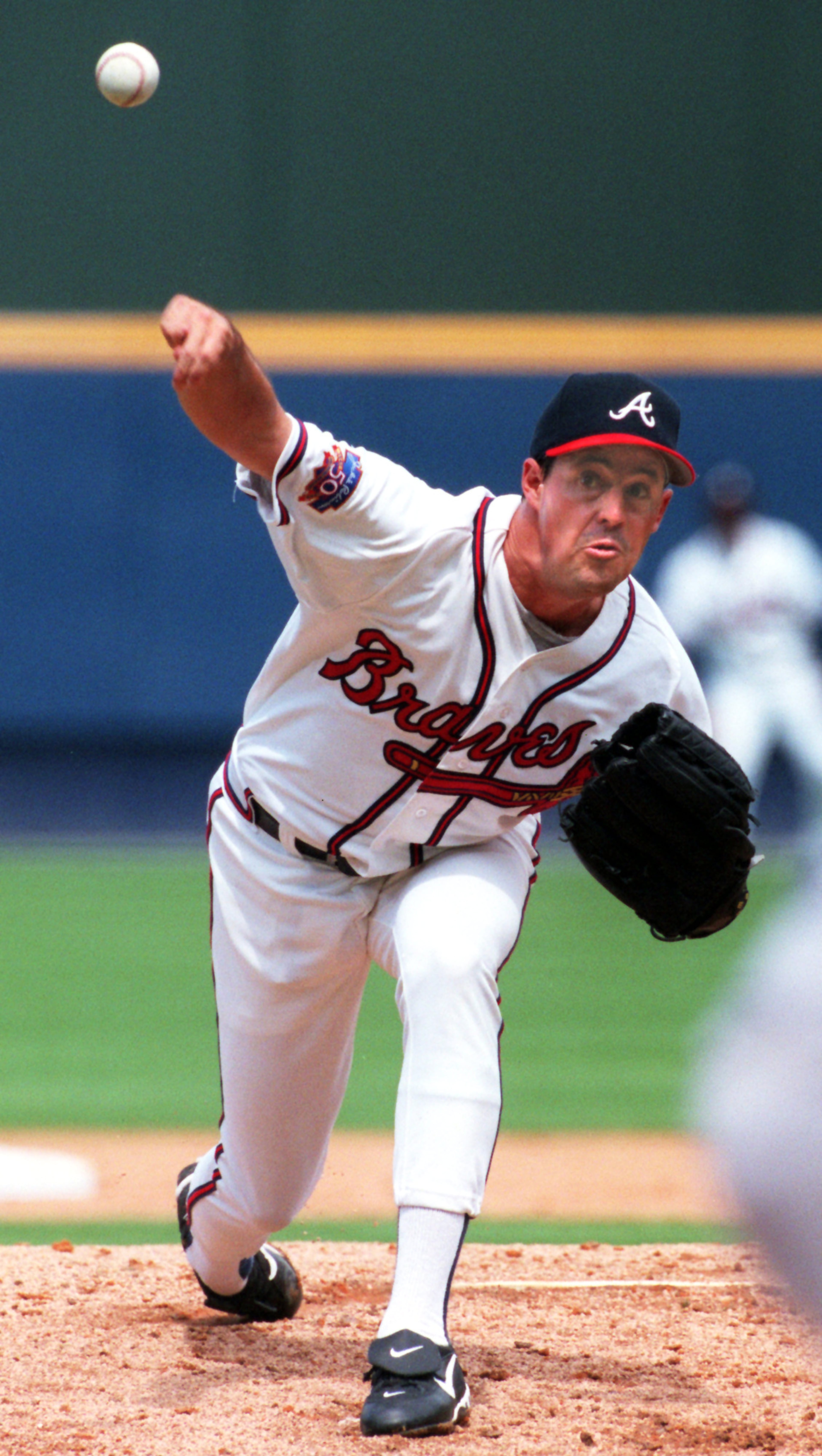 Braves pitcher Greg Maddux delivers in 1997.