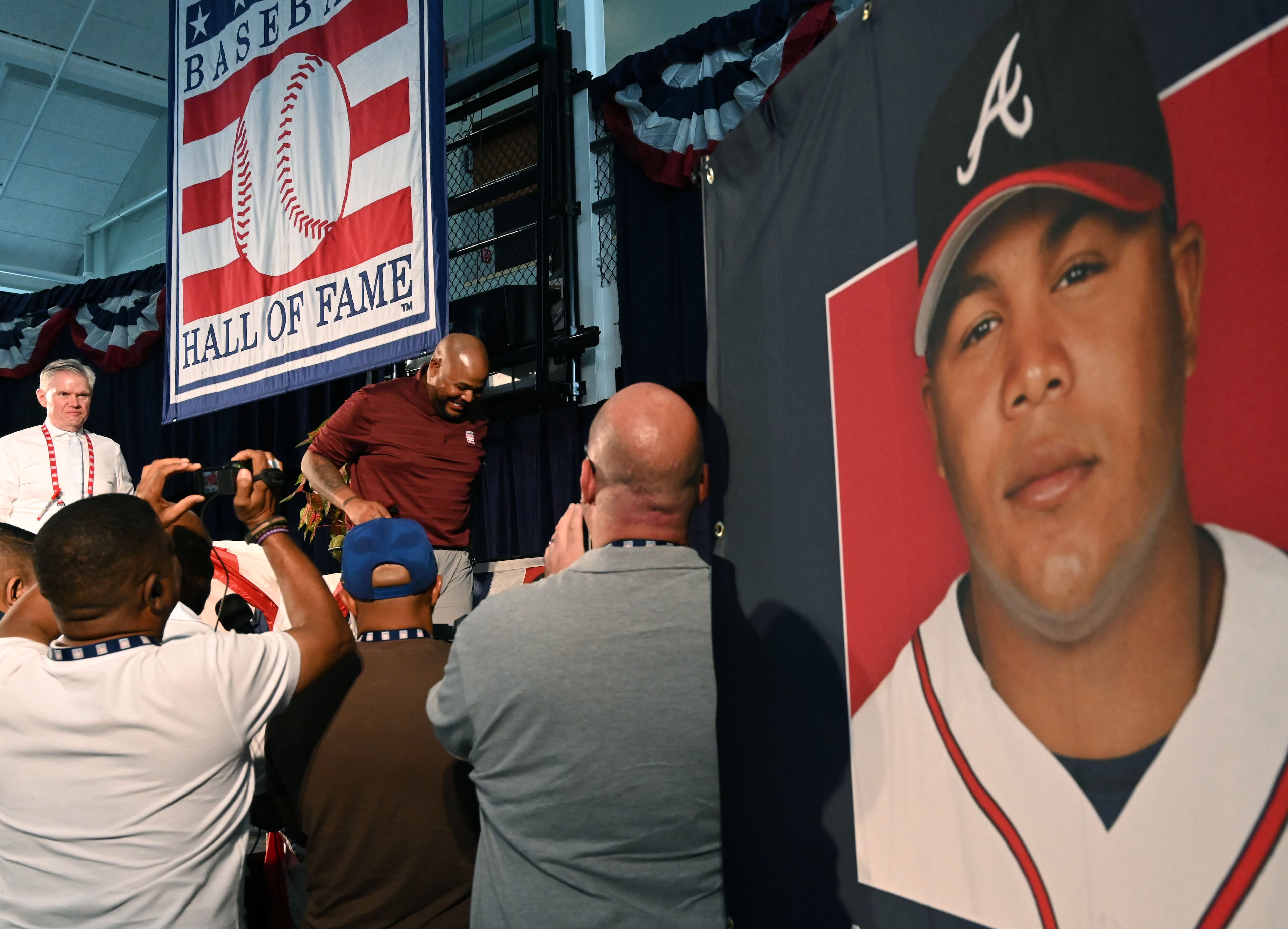 Former Brave Andruw Jones (left center, under banner) leaves after speaking to members of the media during a news conference at the Clark Sports Center on Saturday, July 25, 2026, in Cooperstown, N.Y. Jones will be inducted into the National Baseball Hall of Fame on Sunday as part of the Class of 2026, alongside Carlos Beltrán and Jeff Kent. Jones will become the 12th player with ties to the Atlanta Braves to be inducted into the Hall of Fame. The beloved center fielder was known for his defensive acumen and power. (Hyosub Shin/AJC)