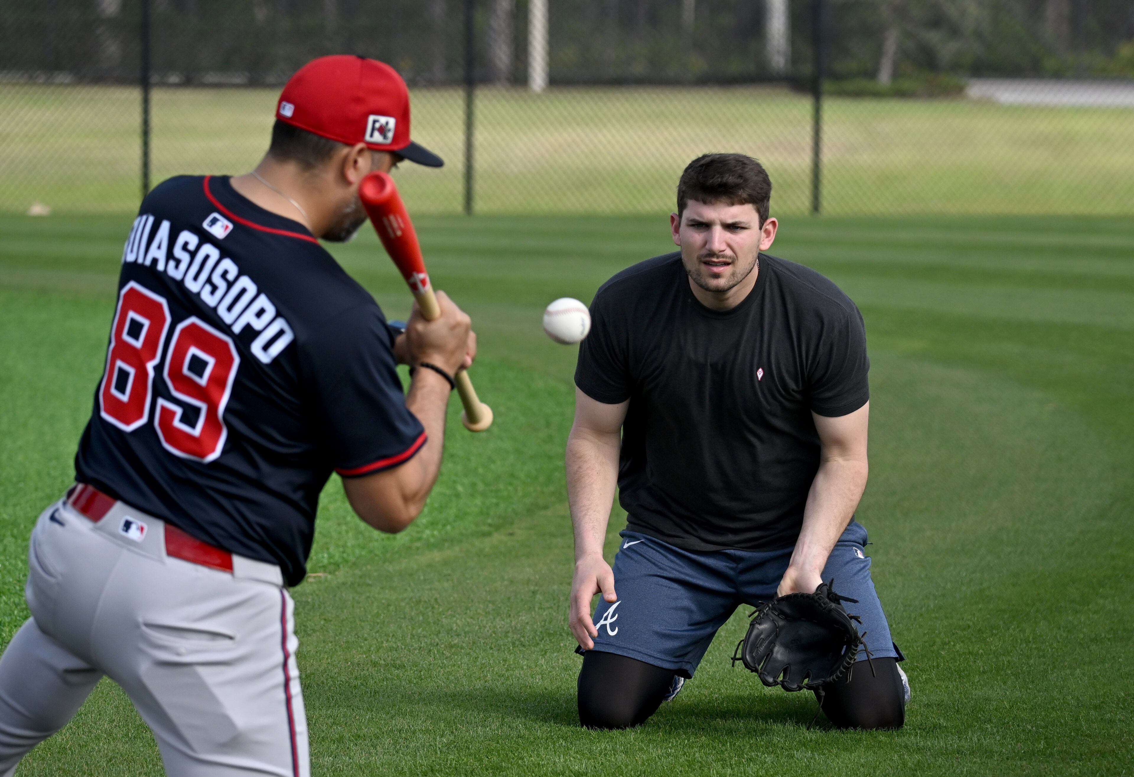 Braves third baseman Austin Riley works on fielding drills with coach Matt Tuiasosopo on Thursday.
