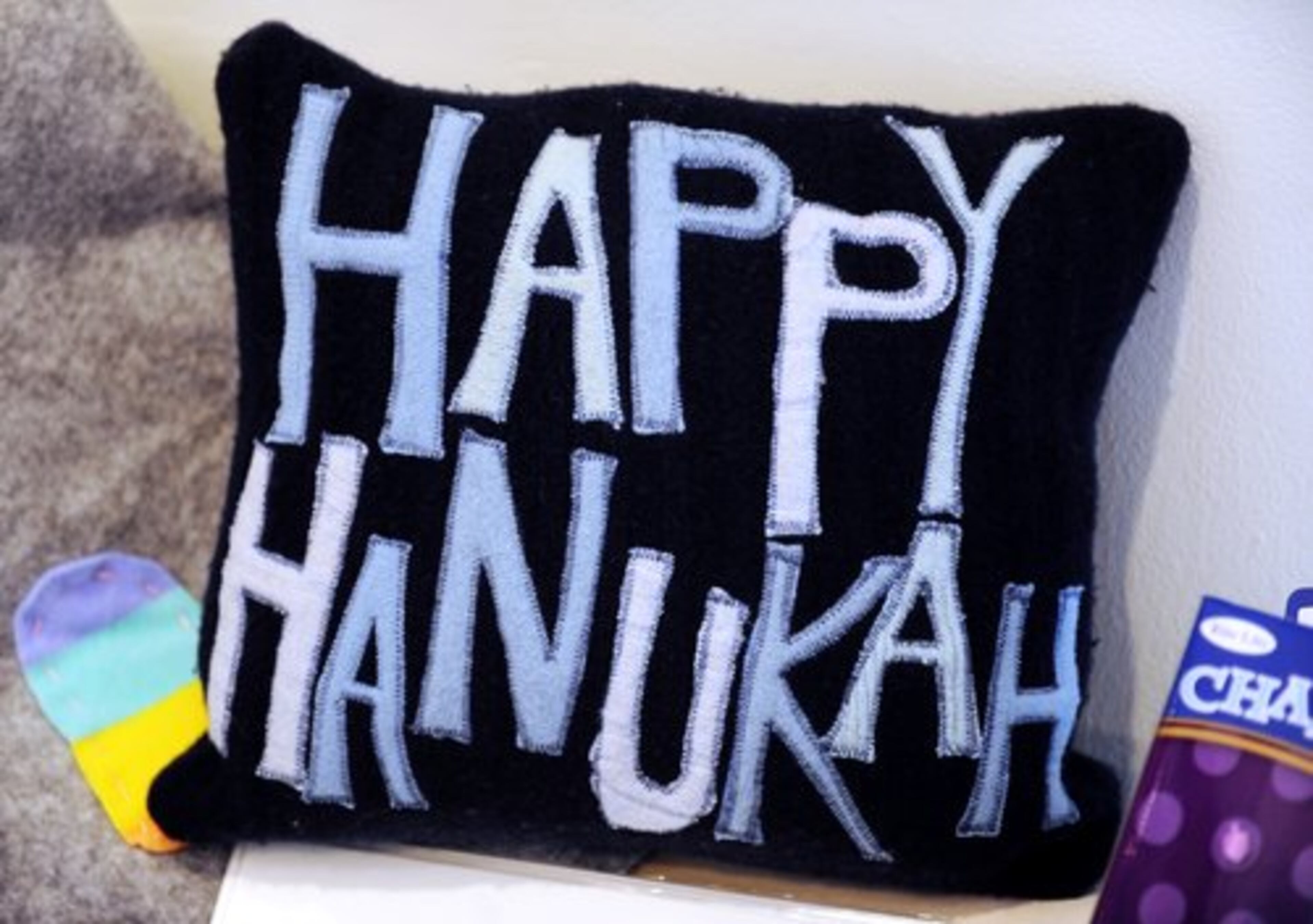 A Hanukah pillow, $40, by artist Cari Newman at the Holiday Artists Market at the Spruill Center for the Arts in Dunwoody.