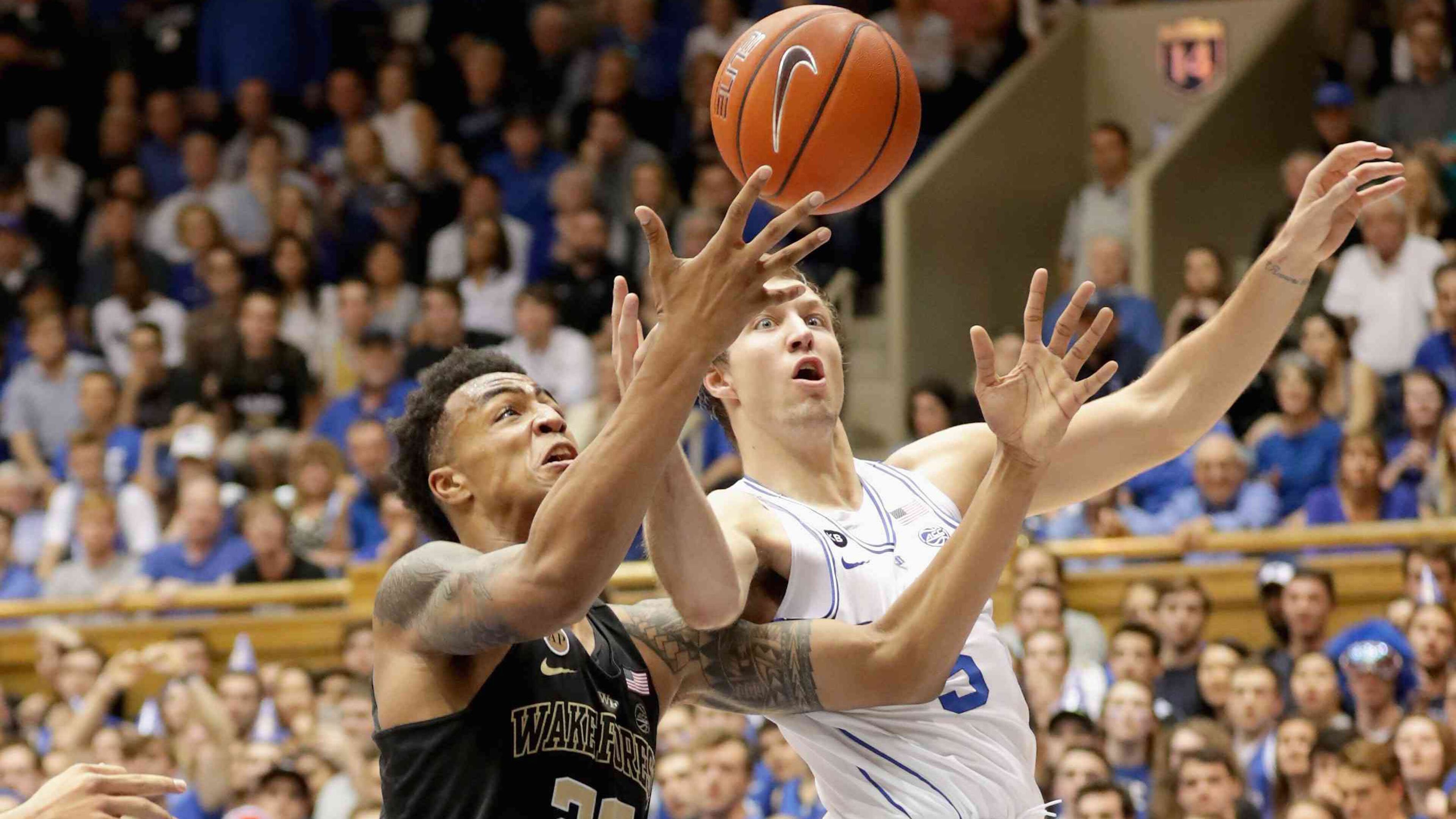 Wake Forest forward John Collins (left) battles for a rebound in a game against Duke last season.