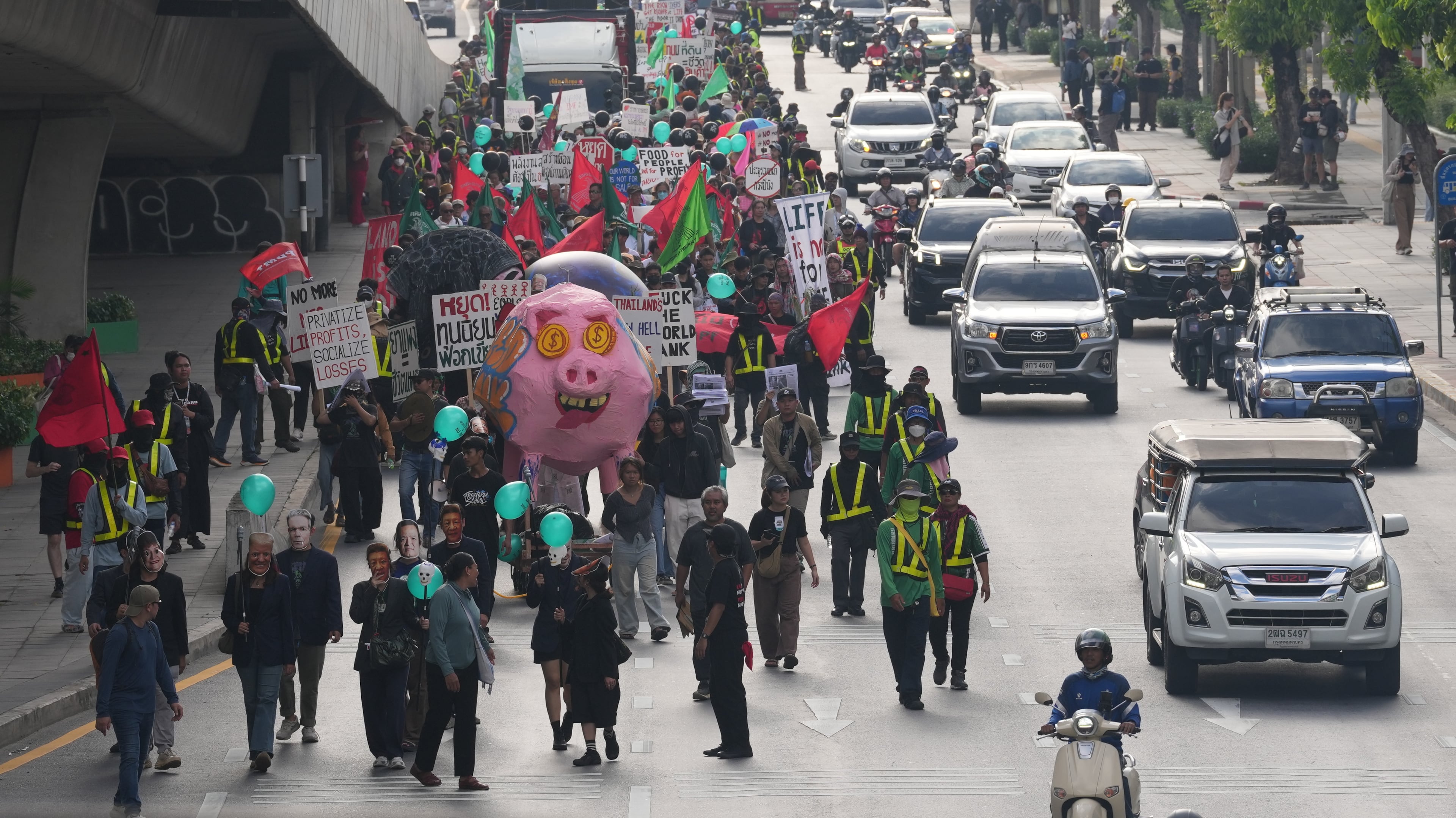 Protesters march to a meeting venue during a demonstration against International Monetary Fund and the World Bank Group in Bangkok, Thailand, Thursday, Oct. 15, 2026. (AP Photo/Sakchai Lalit)