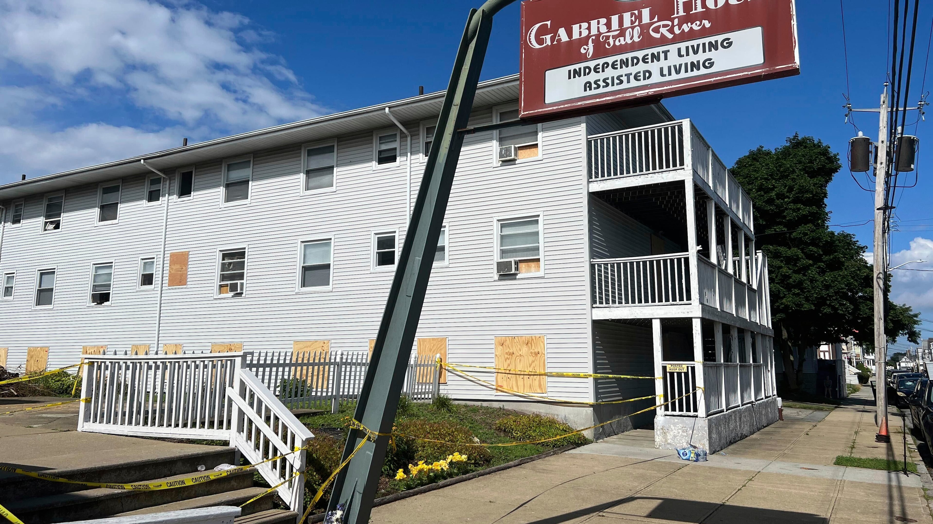 FILE - Boards cover the windows of the Gabriel House assisted living facility, where a fire killed multiple people, July 15, 2025, in Fall River, Mass. (AP Photo/Kimberlee Kruesi, File)