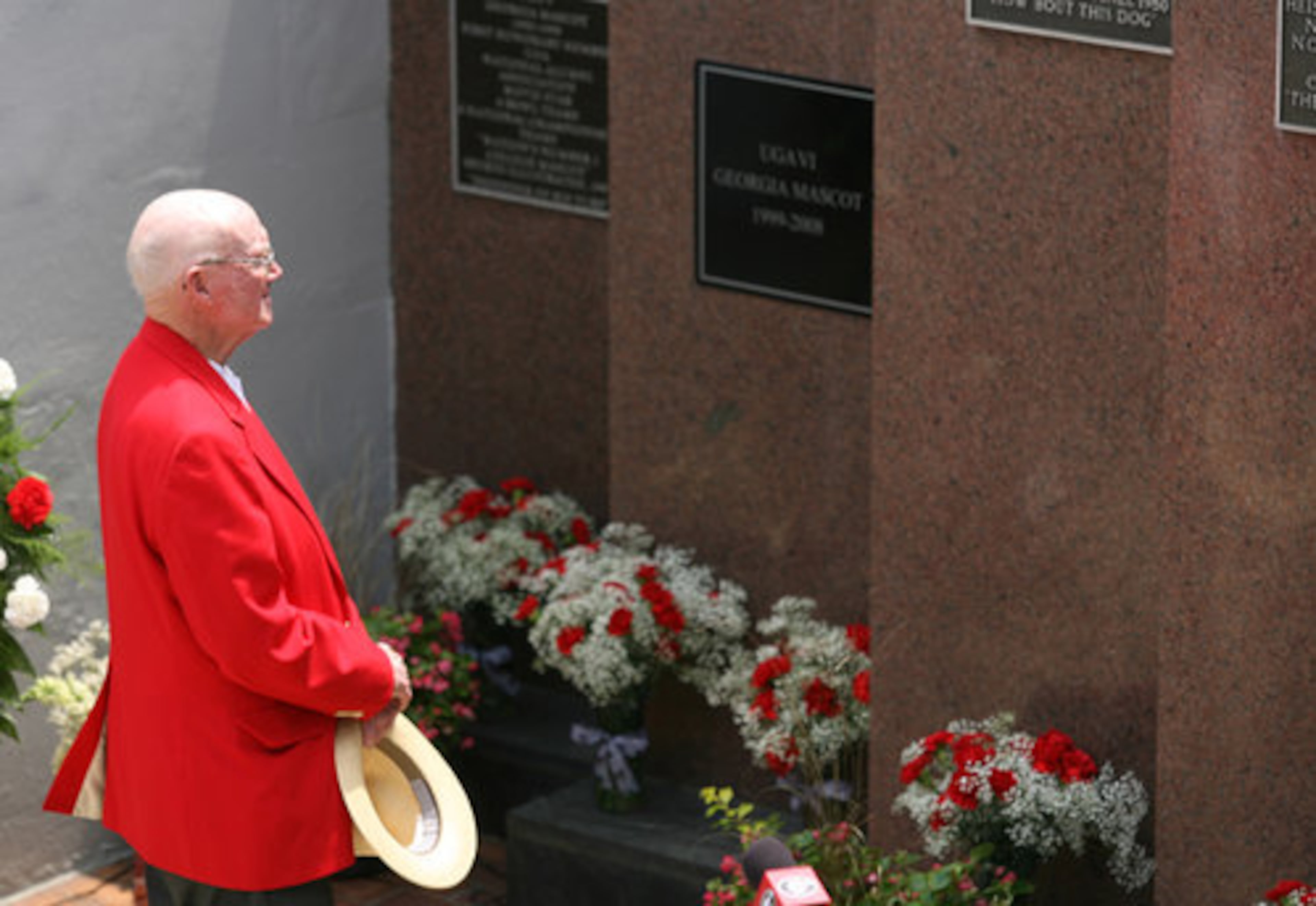 Dan Magill, former Georgia Sports Information Director and head tennis coach, pays his respects to Uga VI. Magill, UGA historian, first designated the Seiler's dog as the new mascot