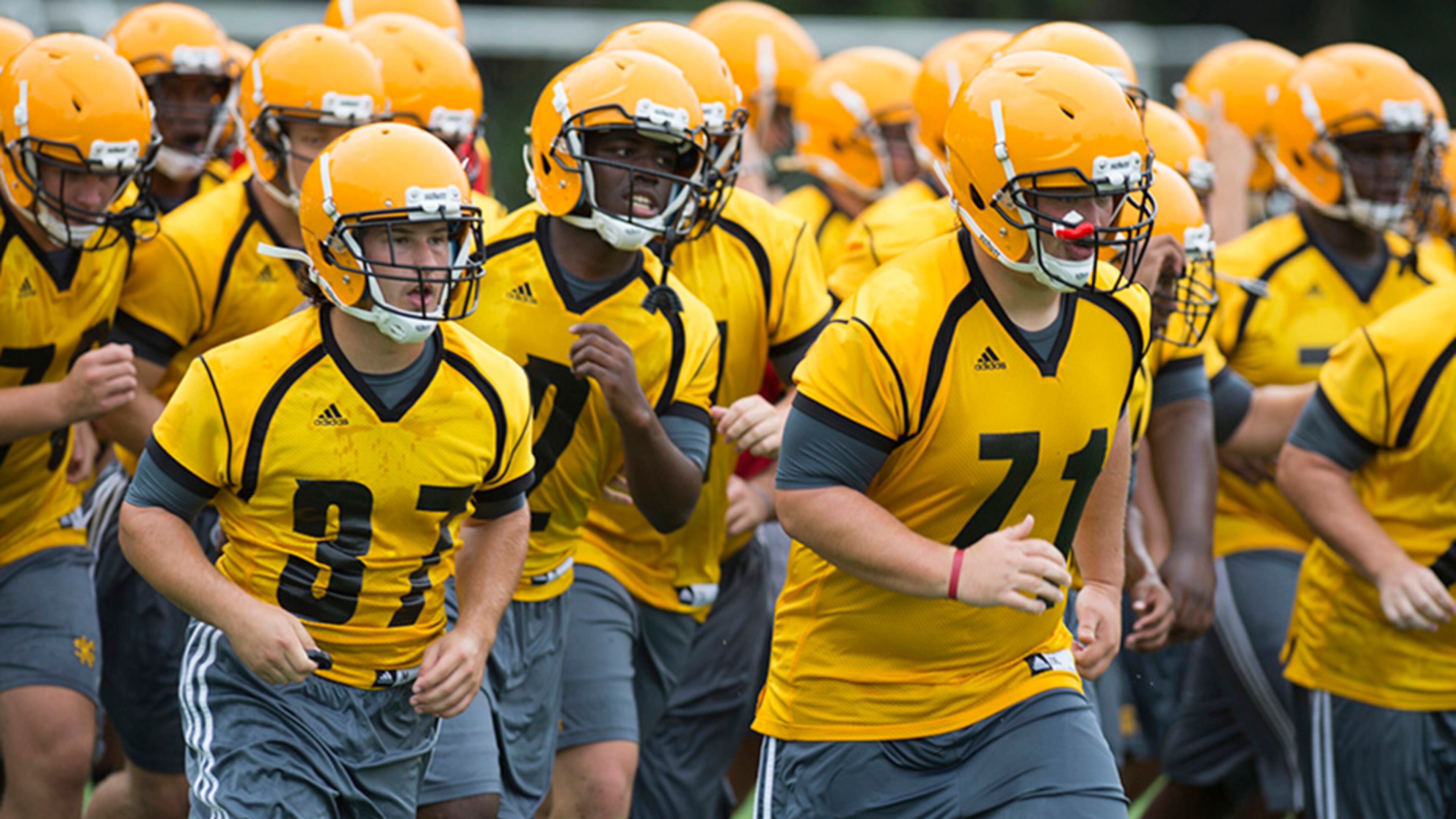 Michael McIntire (37), Jacquez Parks (2) and Brett Gillespie lead the Owls through a practice drill earlier this month. (Kennesaw State)