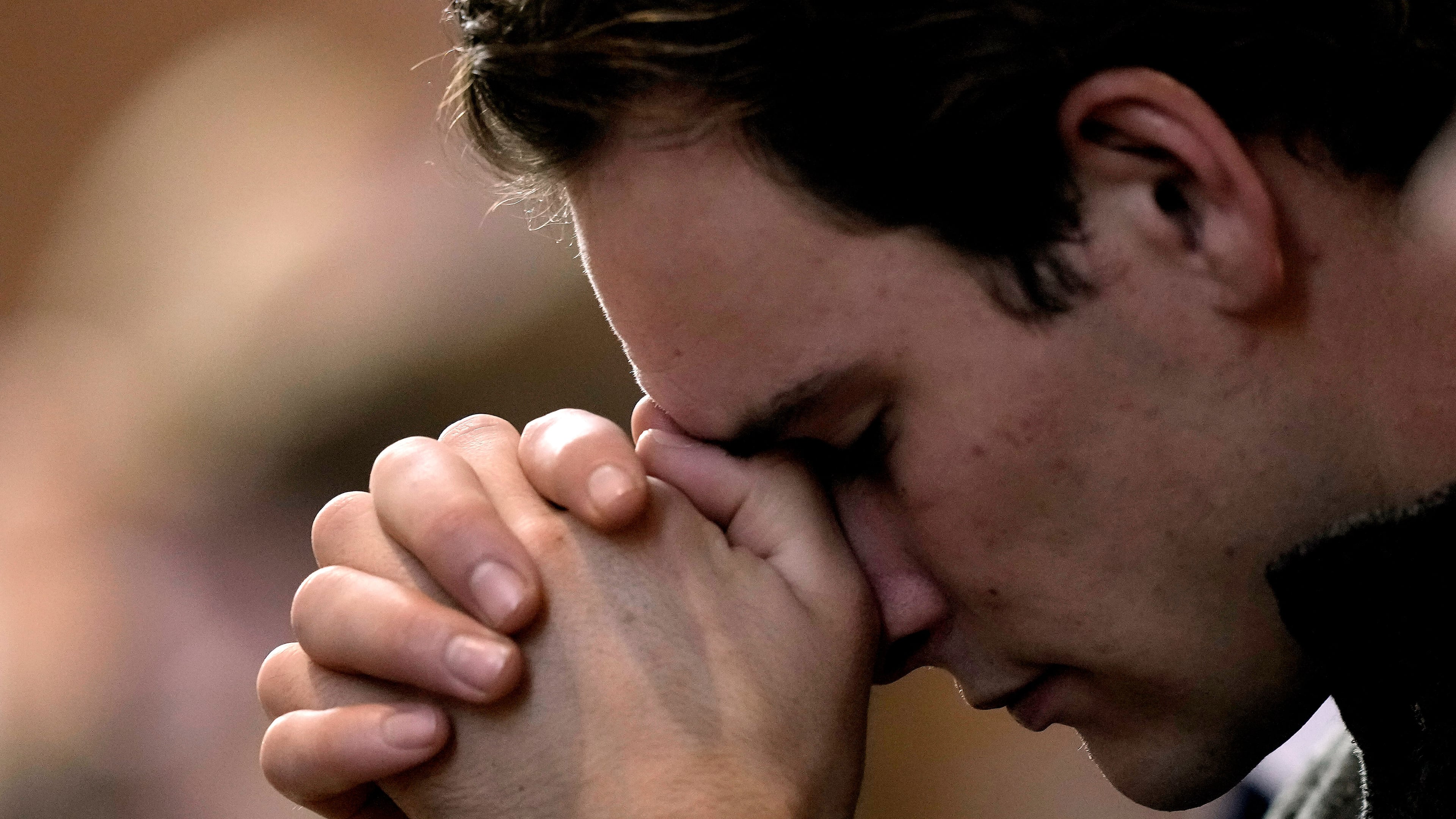 FILE - A man prays during Catholic Mass at Benedictine College, Oct. 29, 2023, in Atchison, Kan. (AP Photo/Charlie Riedel, File)