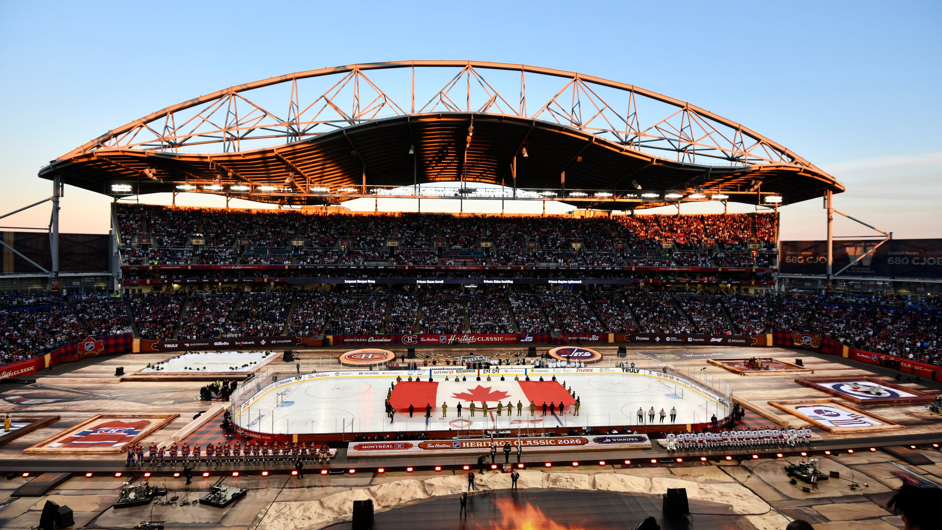 A Canadian flag is unfurled at Princess Auto Stadium before the NHL Heritage Classic hockey game between the Winnipeg Jets and the Montreal Canadiens in Winnipeg, Manitoba, Sunday, Oct. 25, 2026. (Fred Greenslade/The Canadian Press via AP)