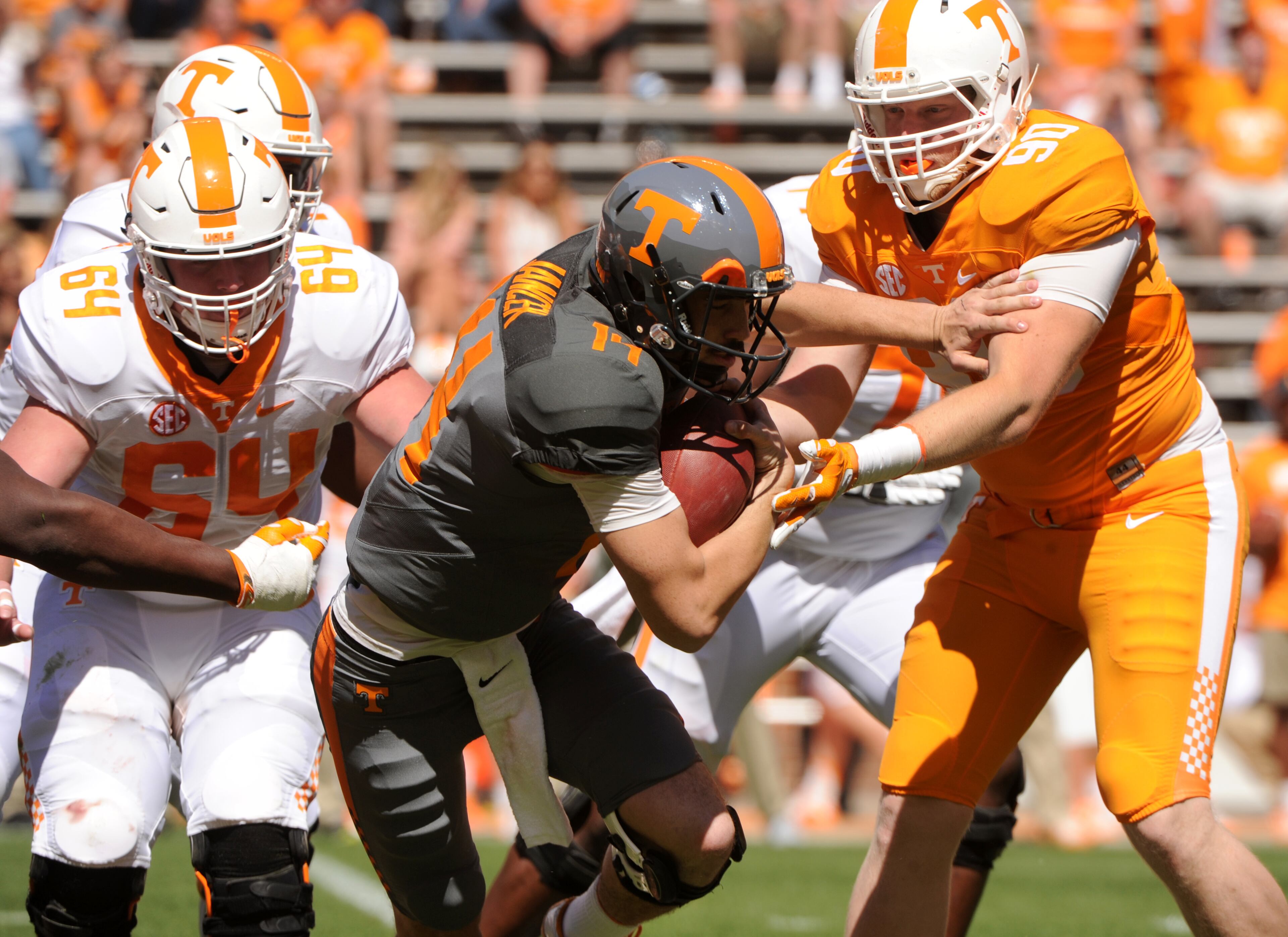Tennessee quarterback Zac Jancek escapes Charles Folger during an NCAA college football spring game in Knoxville, Tenn., Saturday, April 16, 2016. (Michael Patrick/Knoxville News Sentinel via AP)
