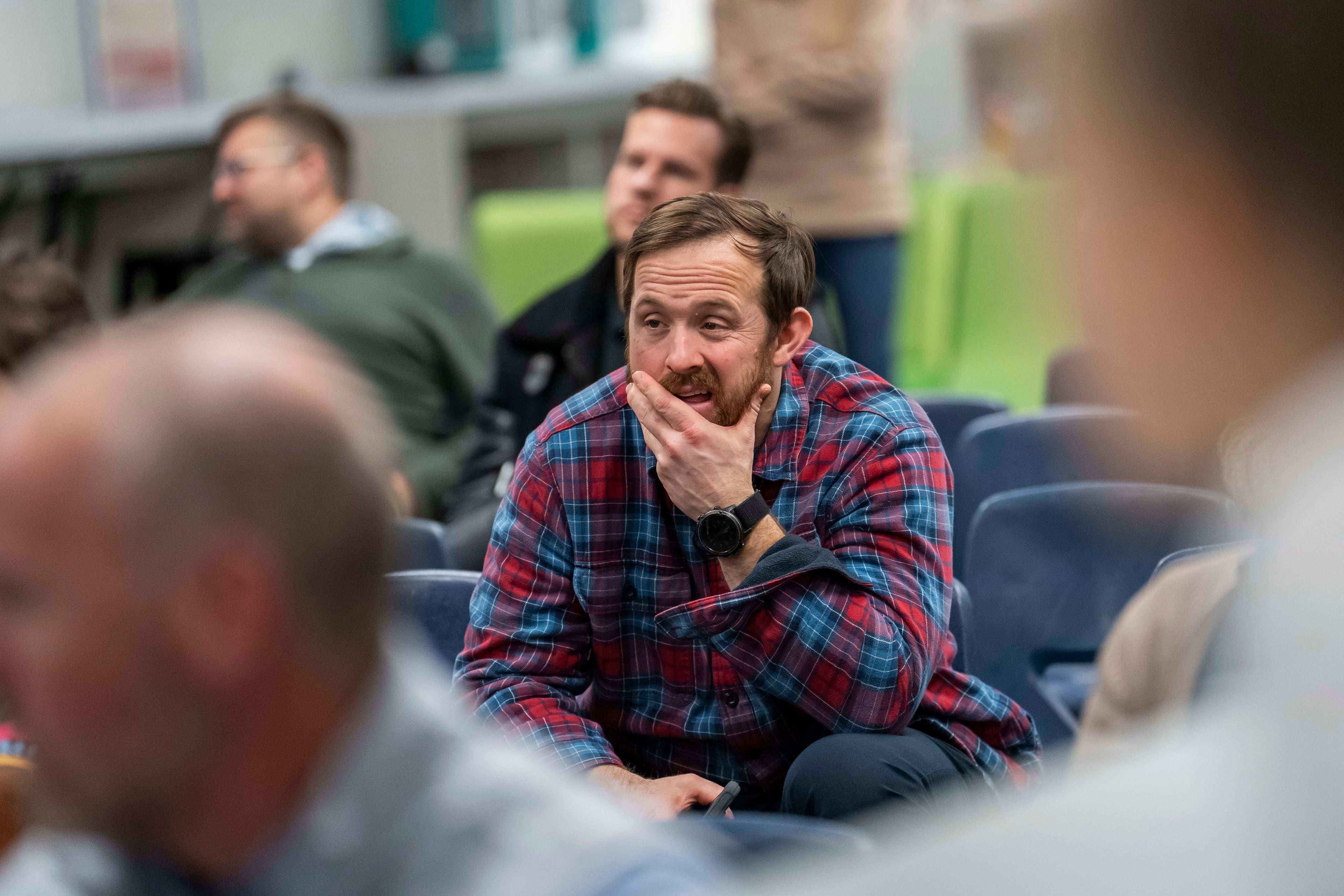 A parent reacts during an informational meeting about the Gwinnett County school system's decision to enforce redshirting rules. (Olivia Bowdoin for the AJC)