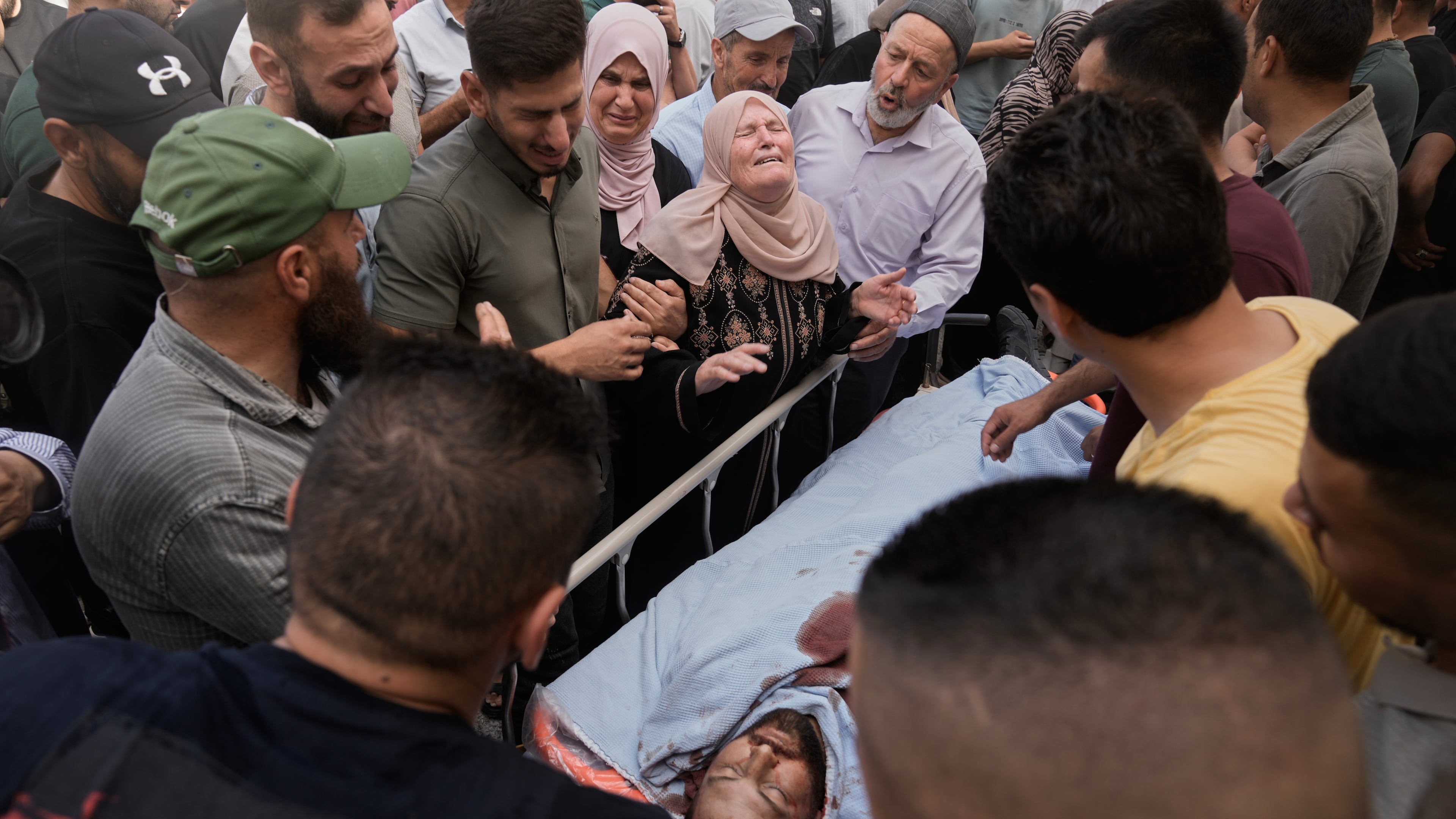 People mourn over the body of Jawad Ramadan, who, according to the Palestinian Health Ministry, was killed by Israeli forces near the village of Tell, after his body was brought to Nablus Speciality Hospital in the West Bank city of Nablus, Friday, July 24, 2026. (AP Photo/Majdi Mohammed)